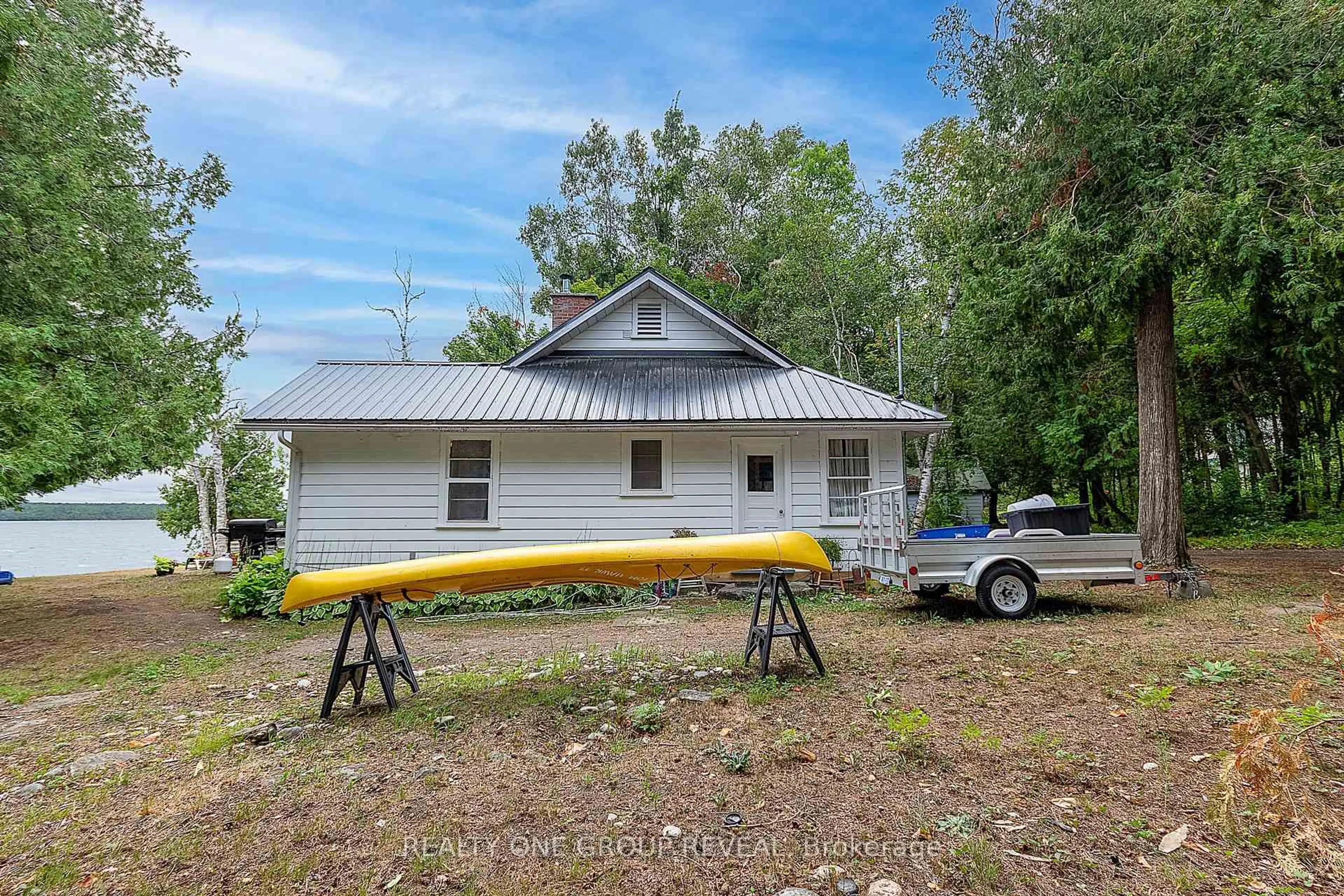 A pic from outside/outdoor area/front of a property/back of a property/a pic from drone, water/lake/river/ocean view for 26 Fire Route 128, Trent Lakes Ontario K0M 1A0