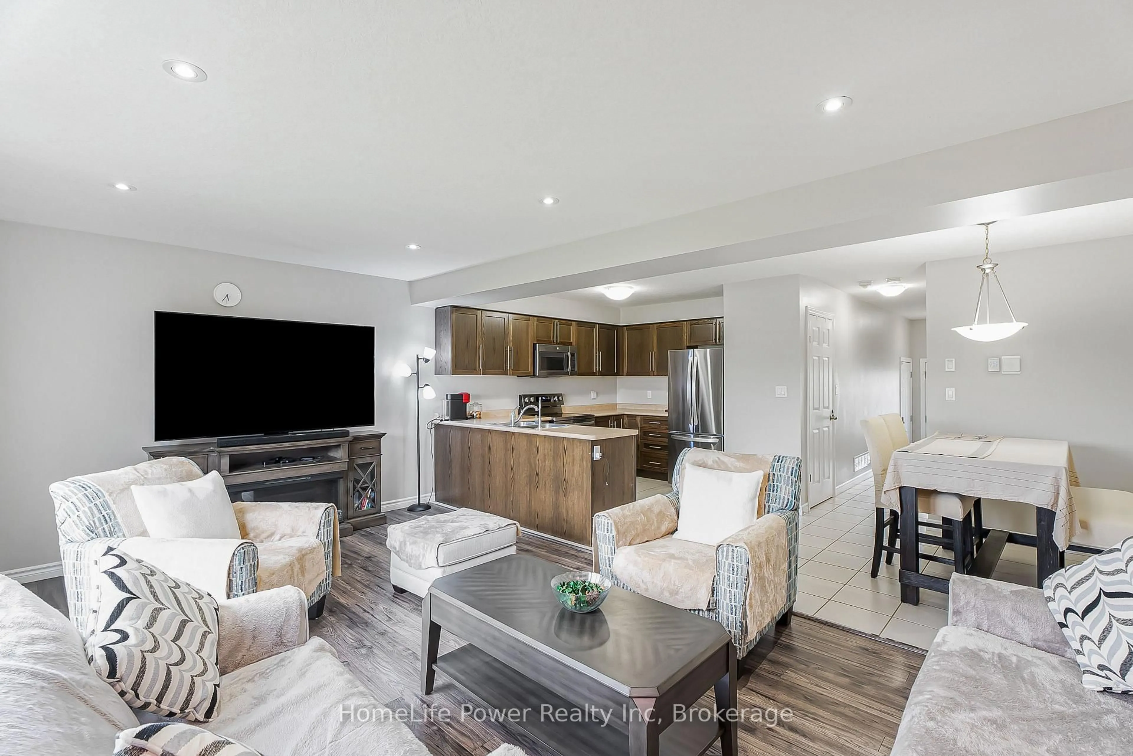 Living room with furniture, wood/laminate floor for 1426 Caen Ave, Woodstock Ontario N4T 0J7