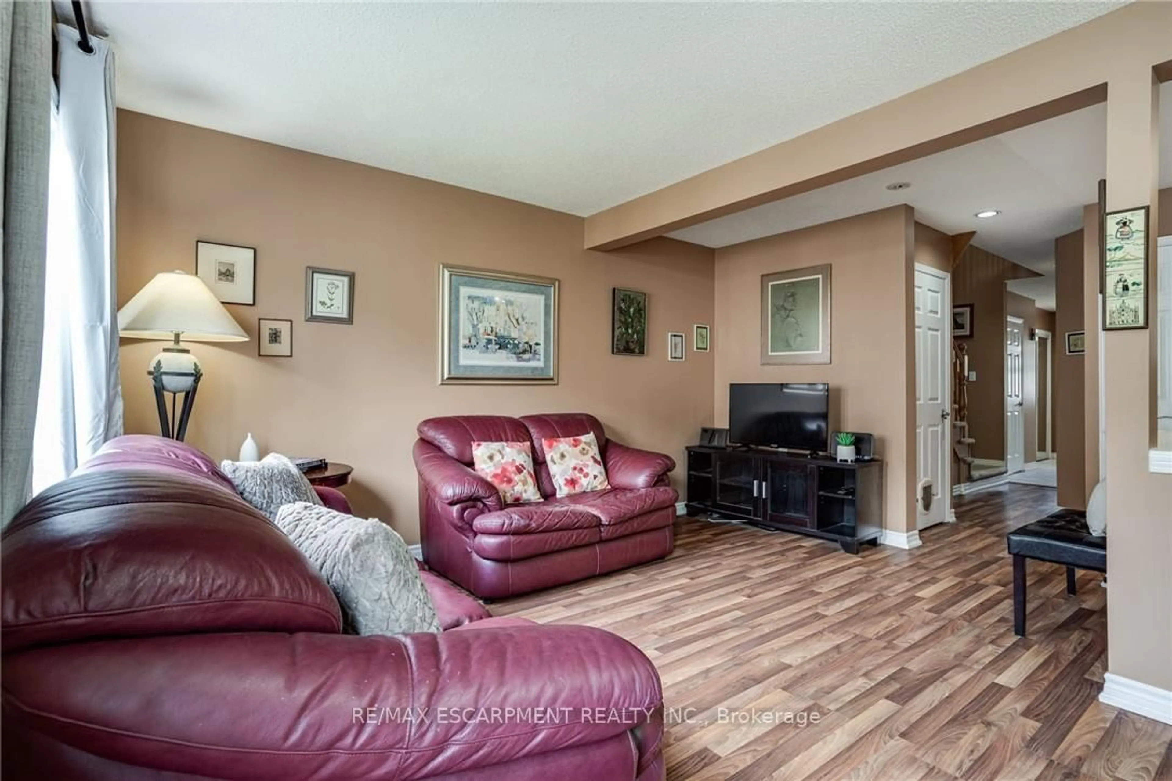 Living room with furniture, wood/laminate floor for 1809 Upper Wentworth St #11, Hamilton Ontario L9B 2R9