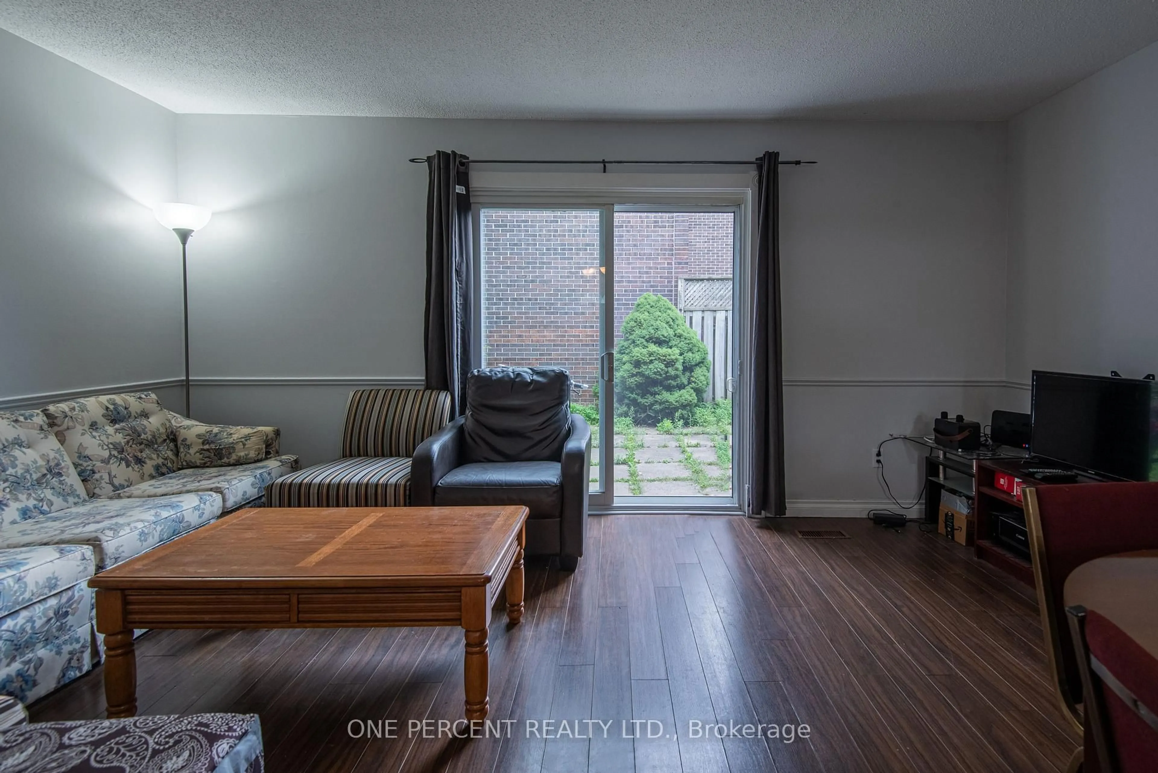 Living room with furniture, wood/laminate floor for 31 Greengate Rd #230, Guelph Ontario N1H 6R3