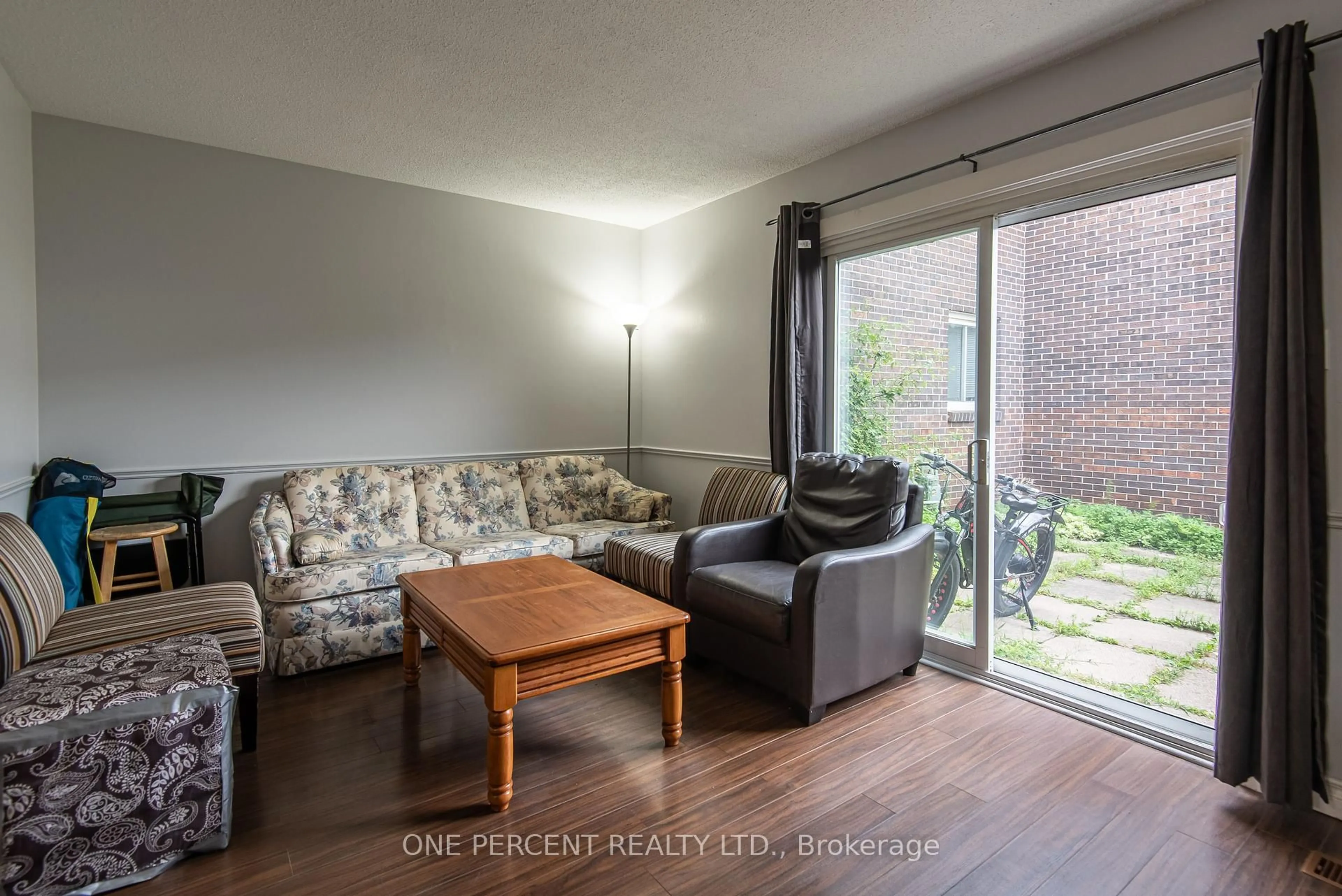 Living room with furniture, wood/laminate floor for 31 Greengate Rd #230, Guelph Ontario N1H 6R3