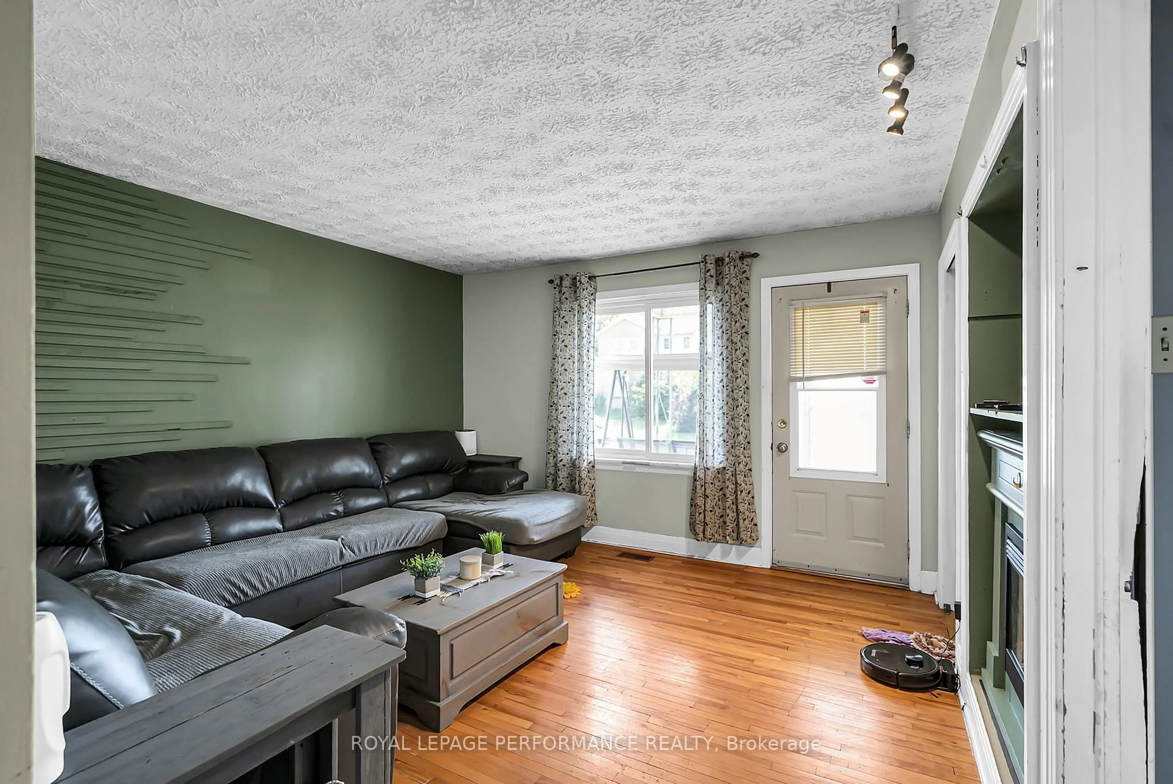 Living room with furniture, wood/laminate floor for 409 Belmont St, Cornwall Ontario K6H 4Z8