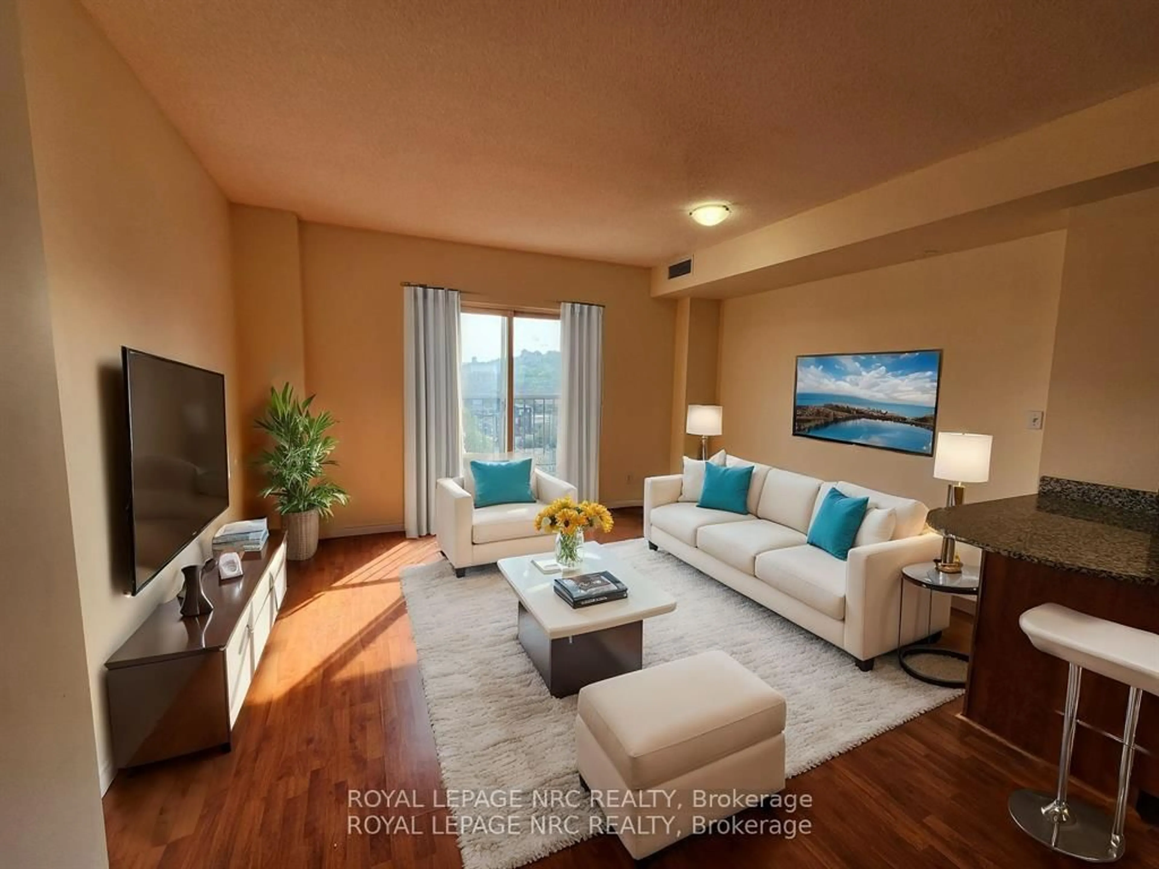 Living room with furniture, wood/laminate floor for 135 JAMES St #812, Hamilton Ontario L8P 2Z6