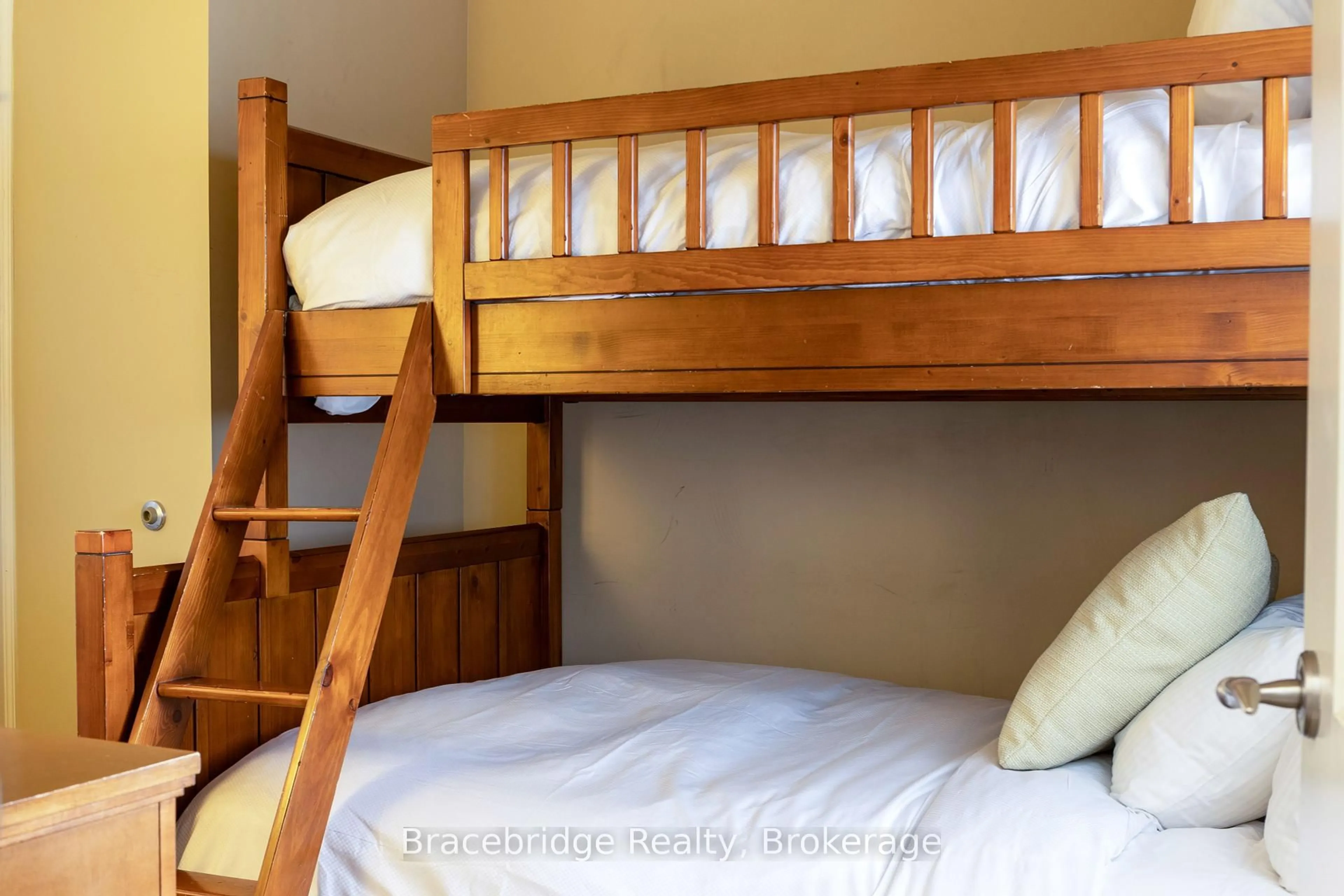 Bedroom with bed, wood/laminate floor for 1869 Muskoka 118 Rd #A202-D1, Muskoka Lakes Ontario P1L 1W8