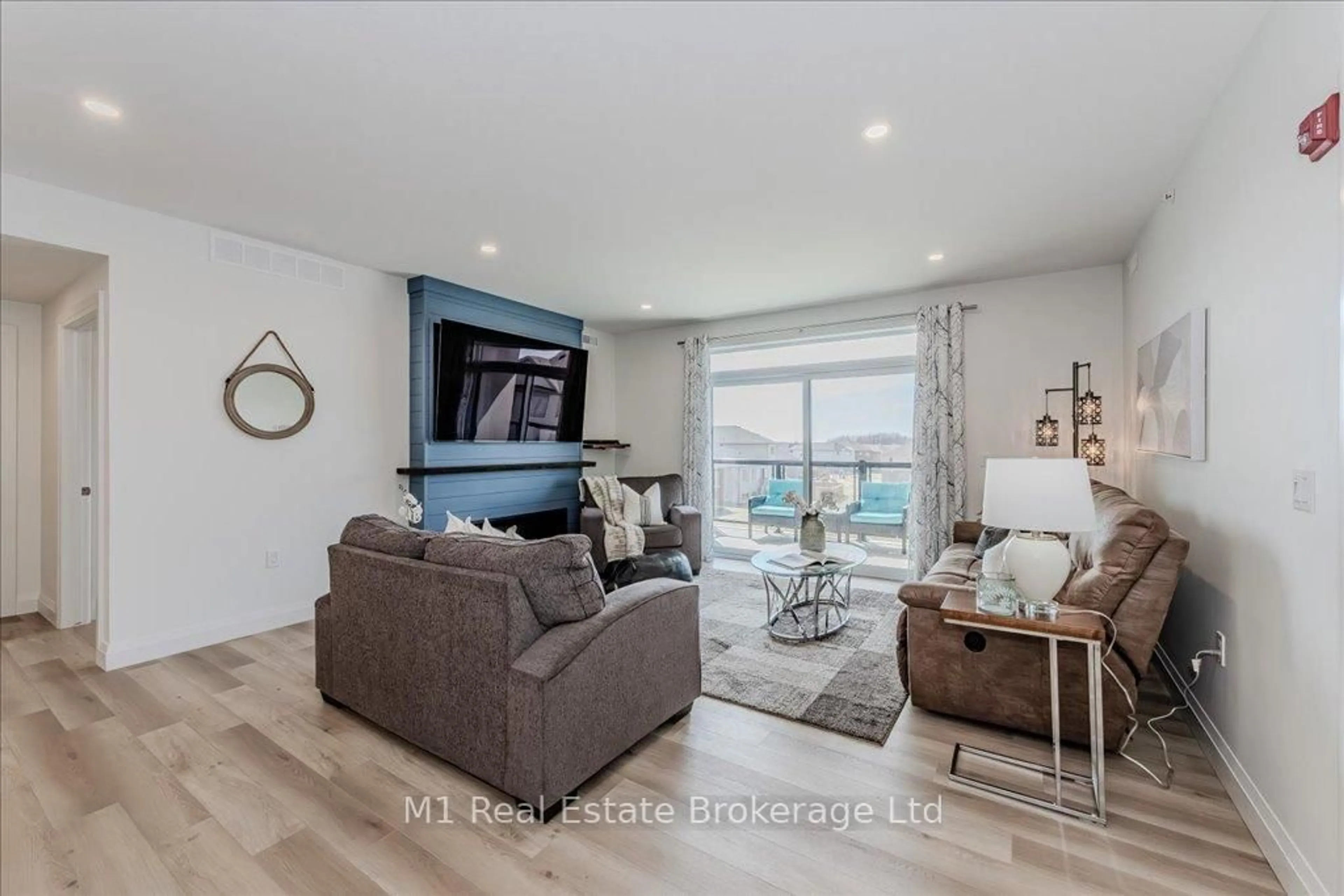 Living room with furniture, wood/laminate floor for 99B Farley Rd #207, Centre Wellington Ontario N1M 0J9