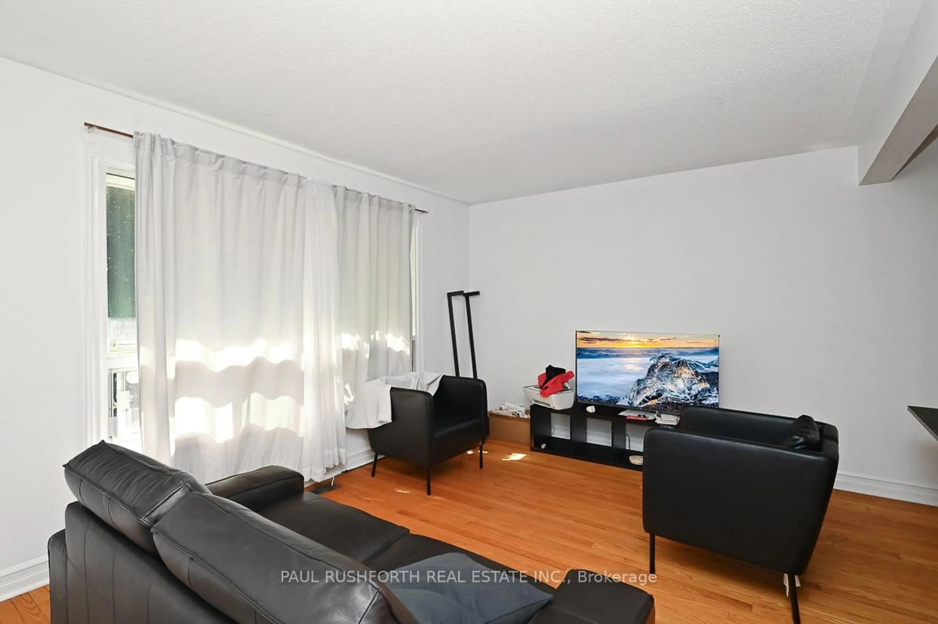 Living room with furniture, wood/laminate floor for 845 Trojan Ave, Ottawa Ontario K1K 2P8