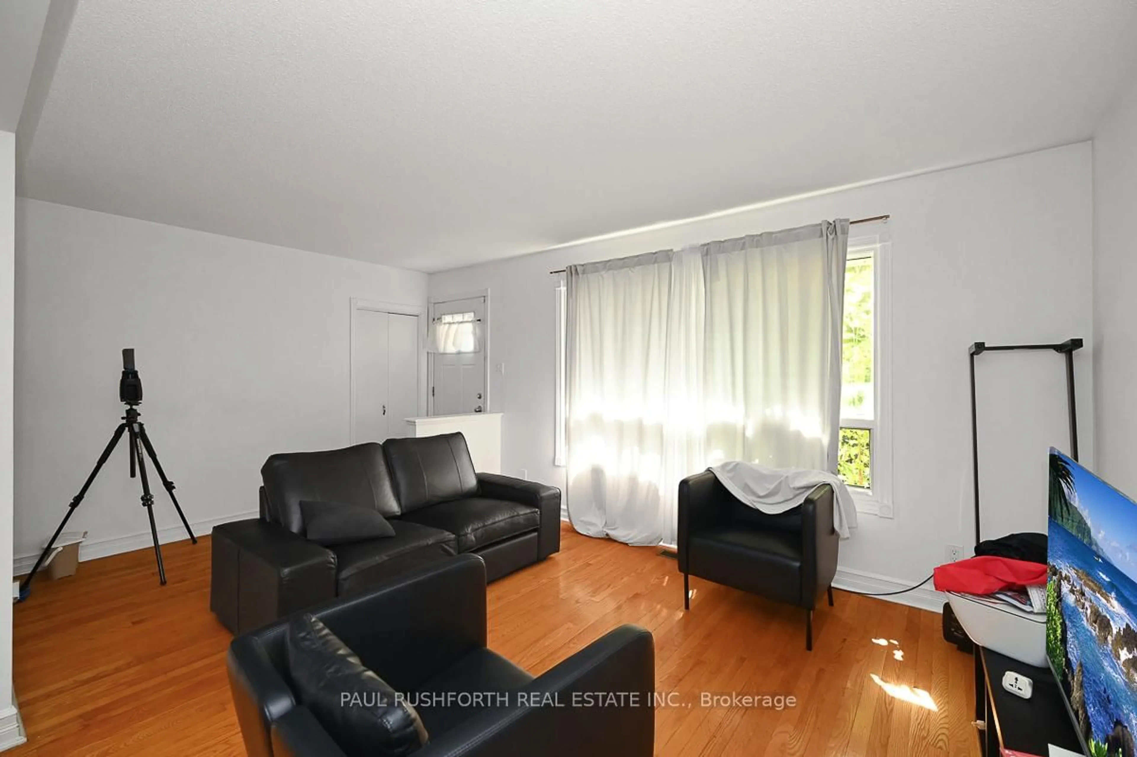 Living room with furniture, wood/laminate floor for 845 Trojan Ave, Ottawa Ontario K1K 2P8