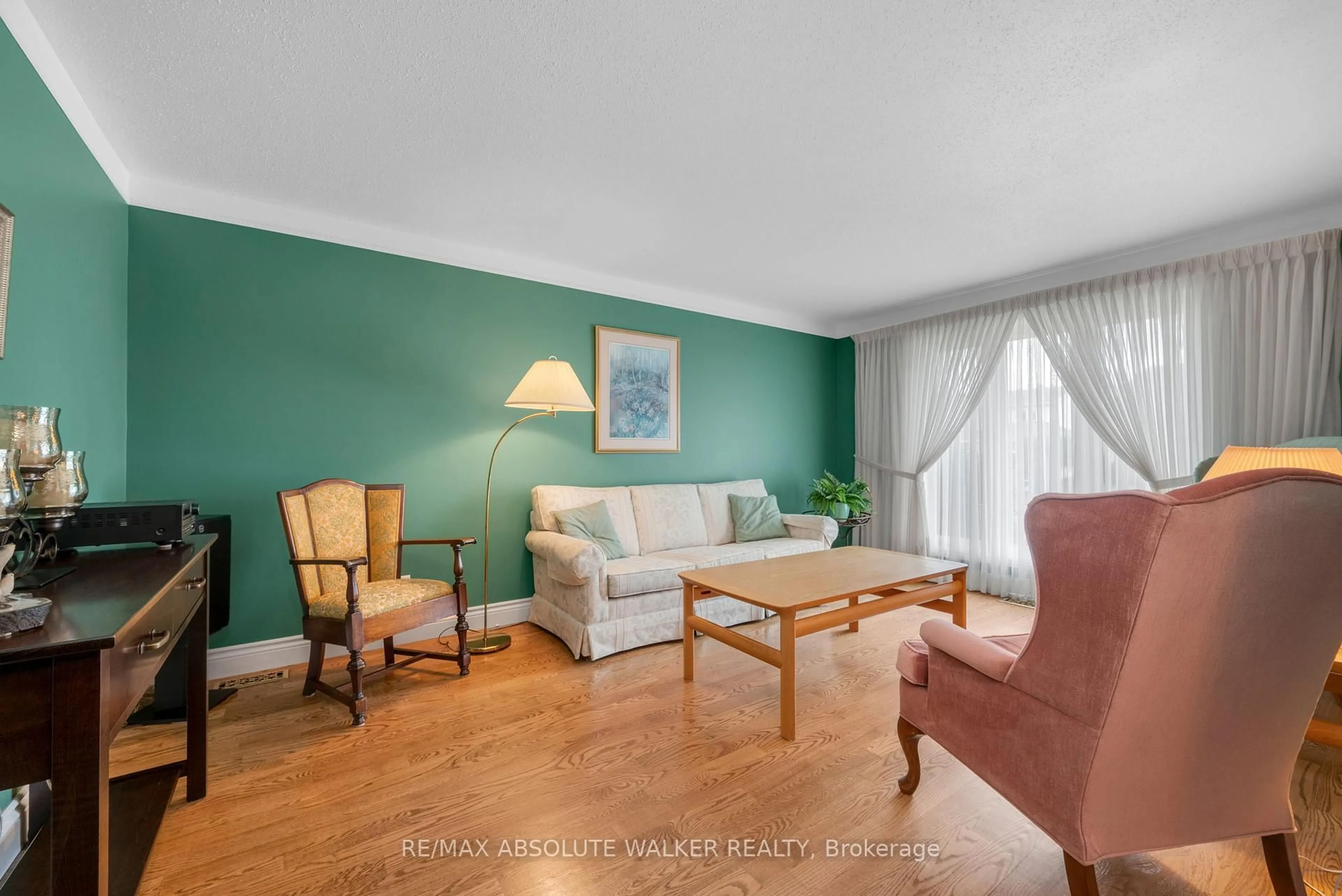 Living room with furniture, wood/laminate floor for 501 Harrowsmith Way, Orleans Ontario K4A 2Z2