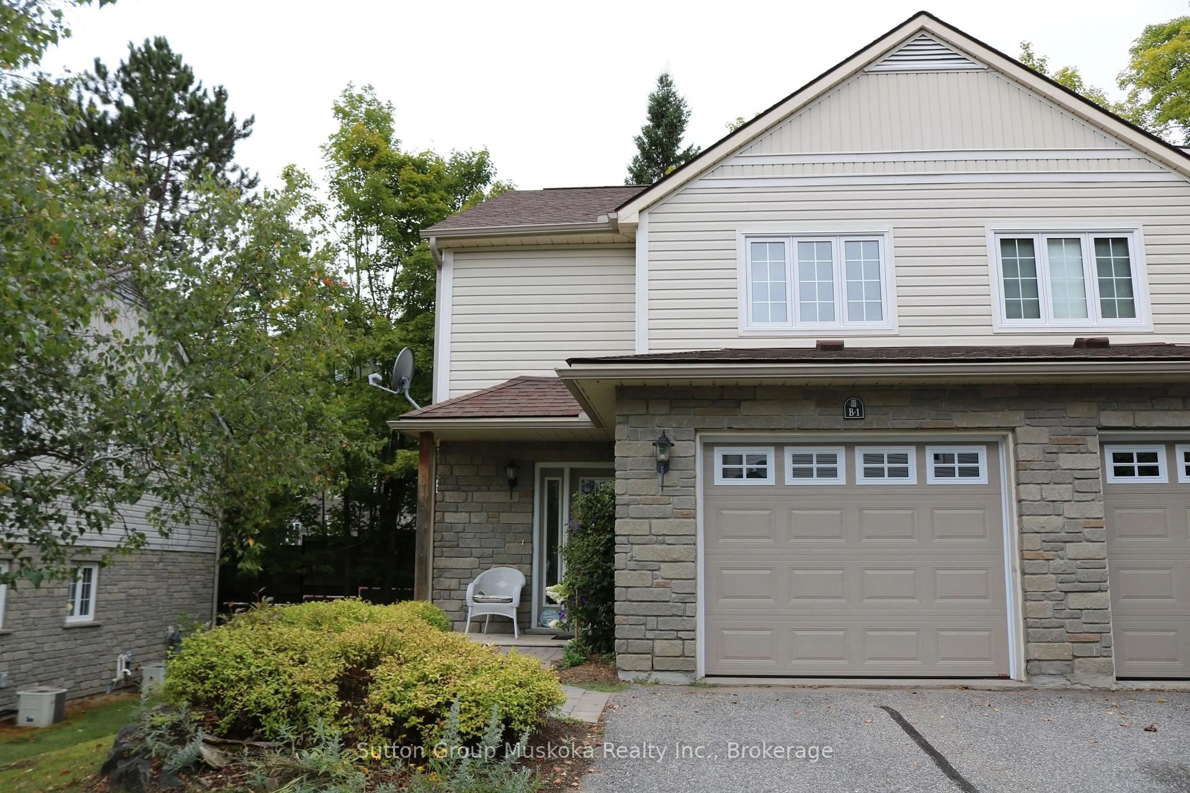 Home with vinyl exterior material, street for 20 Dairy Lane #B1, Huntsville Ontario P1H 2L1