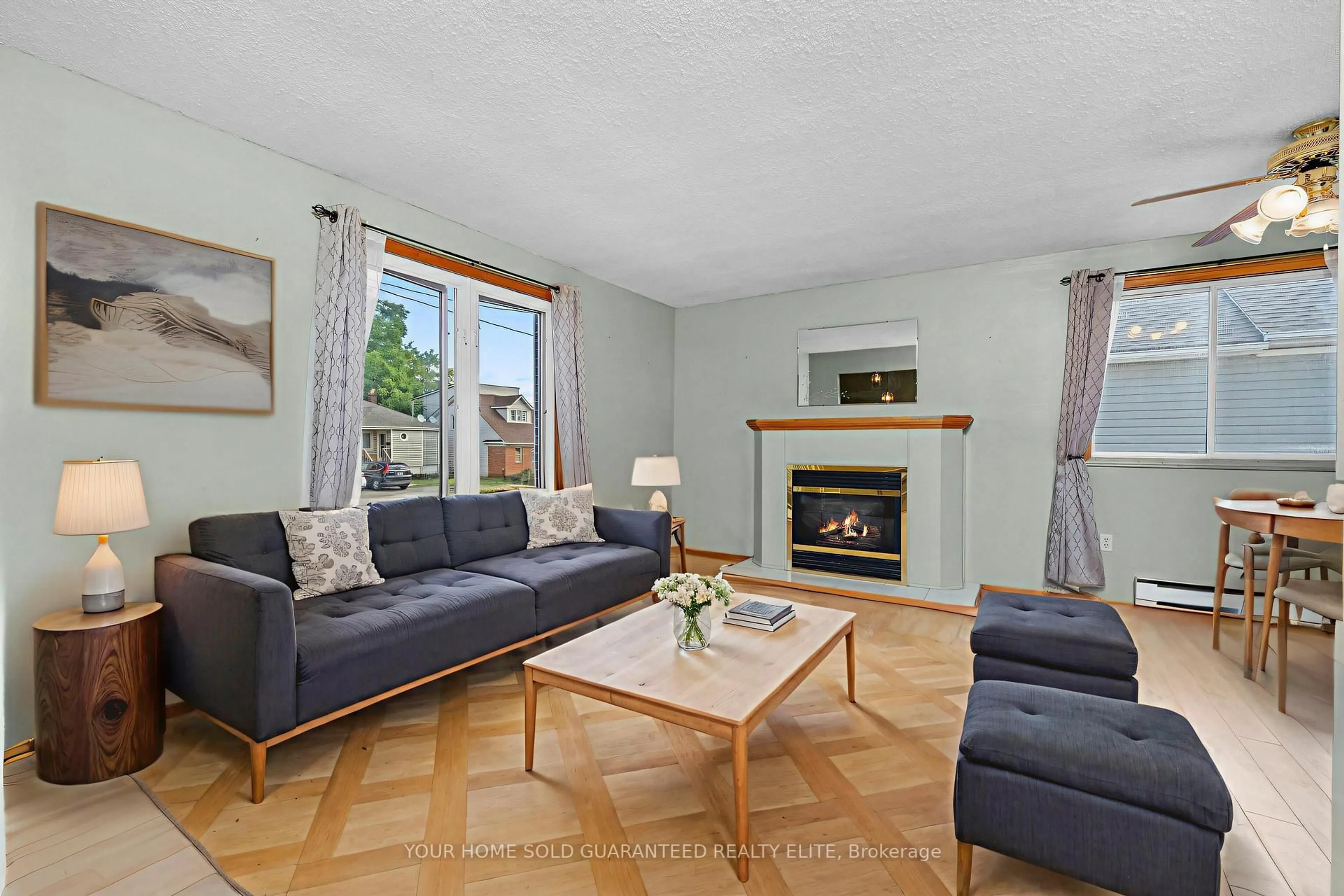 Living room with furniture, wood/laminate floor for 13 Cumming St, St. Catharines Ontario L2S 1H6