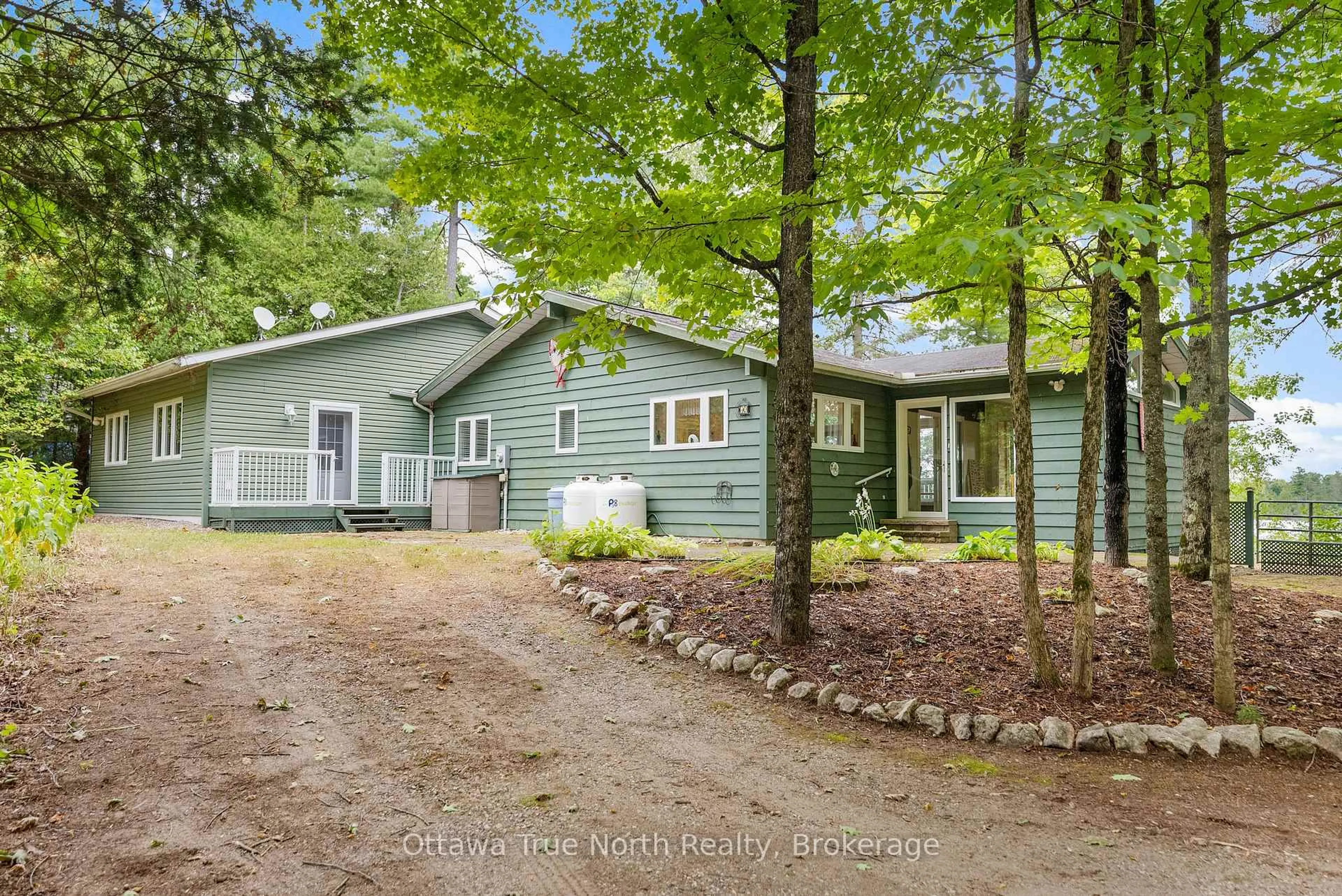 A pic from outside/outdoor area/front of a property/back of a property/a pic from drone, forest/trees view for 63 Frost Lane, Calabogie Ontario K0J 1H0