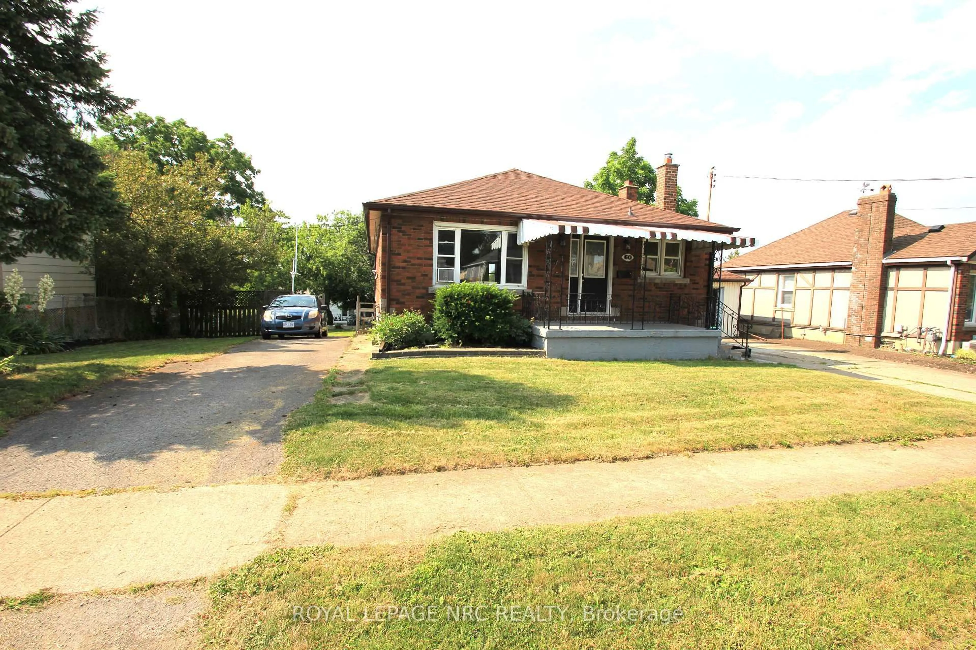 Home with brick exterior material, street for 60 Michael Ave, St. Catharines Ontario L2T 1S3