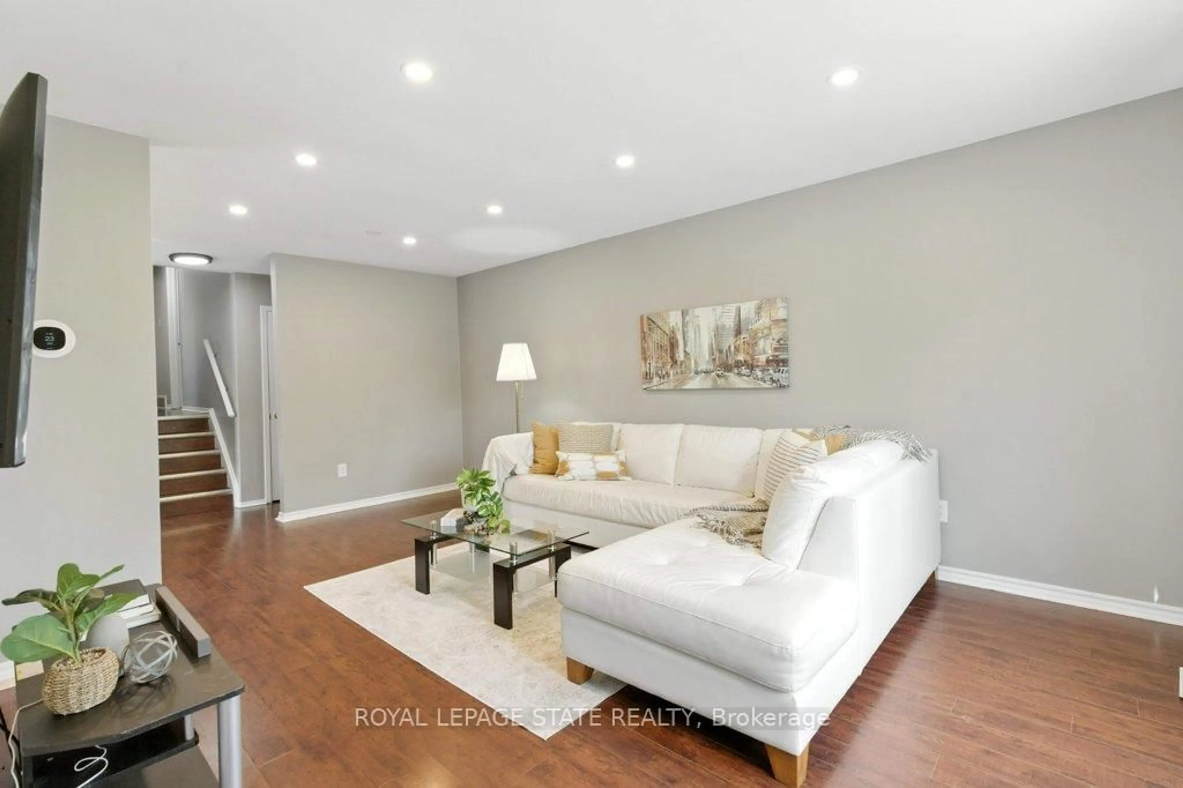 Living room with furniture, wood/laminate floor for 19 Lampman Cres, Thorold Ontario L2V 4K6