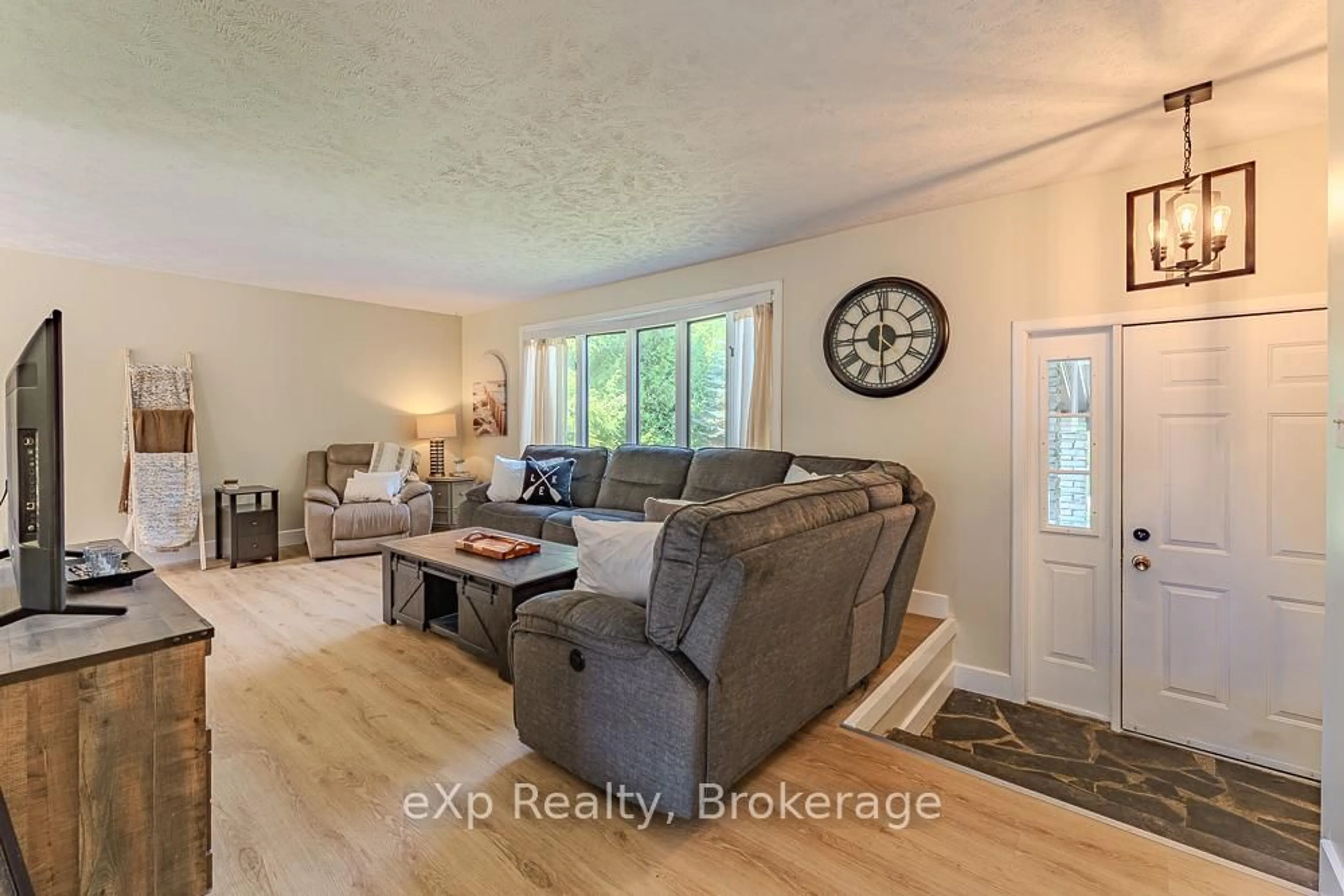 Living room with furniture, wood/laminate floor for 502354 Grey Road 1 Rd, Georgian Bluffs Ontario N0H 2T0