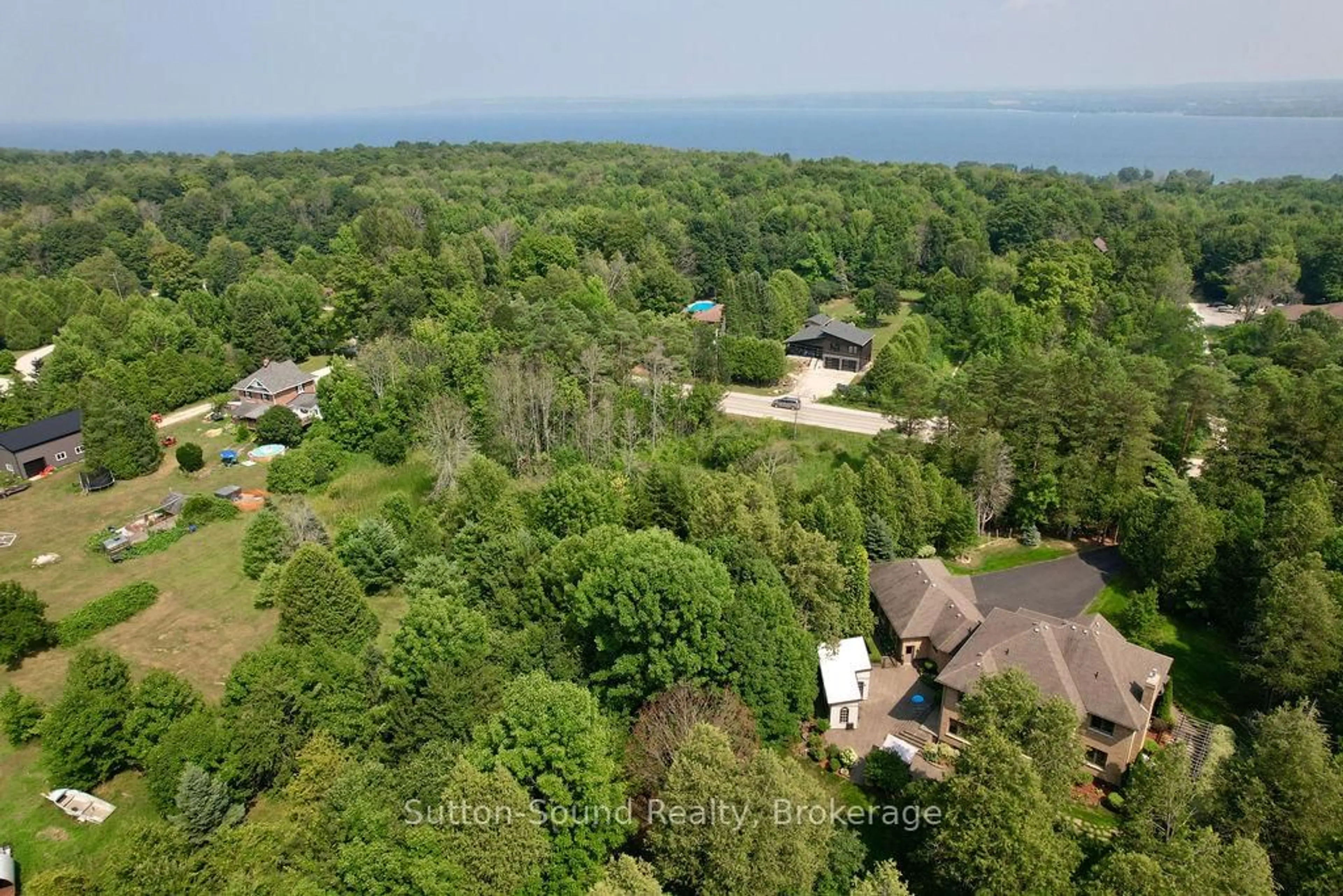 A pic from outside/outdoor area/front of a property/back of a property/a pic from drone, water/lake/river/ocean view for 318760 Grey Road 1 Rd, Georgian Bluffs Ontario N4K 5N4
