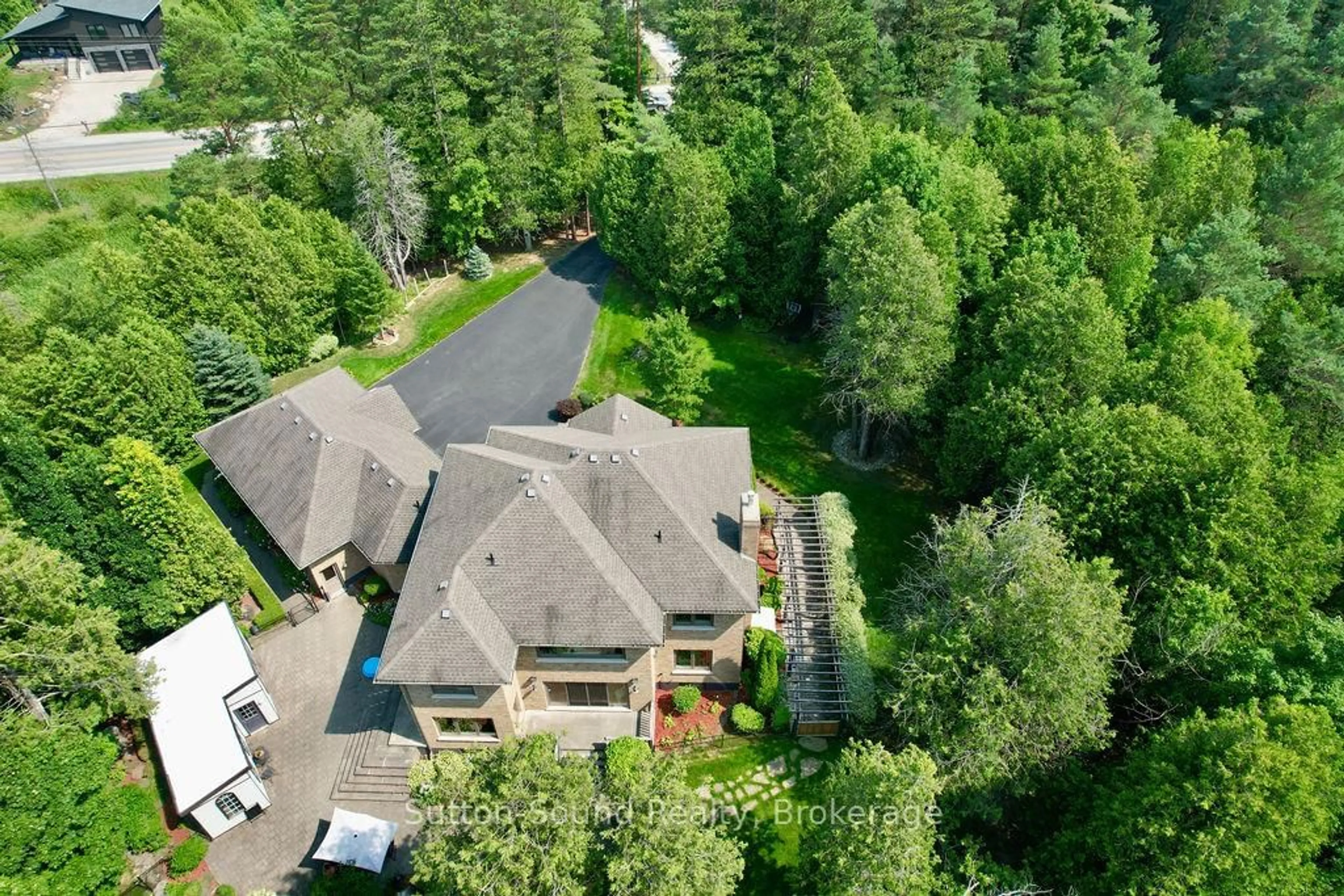 A pic from outside/outdoor area/front of a property/back of a property/a pic from drone, forest/trees view for 318760 Grey Road 1 Rd, Georgian Bluffs Ontario N4K 5N4