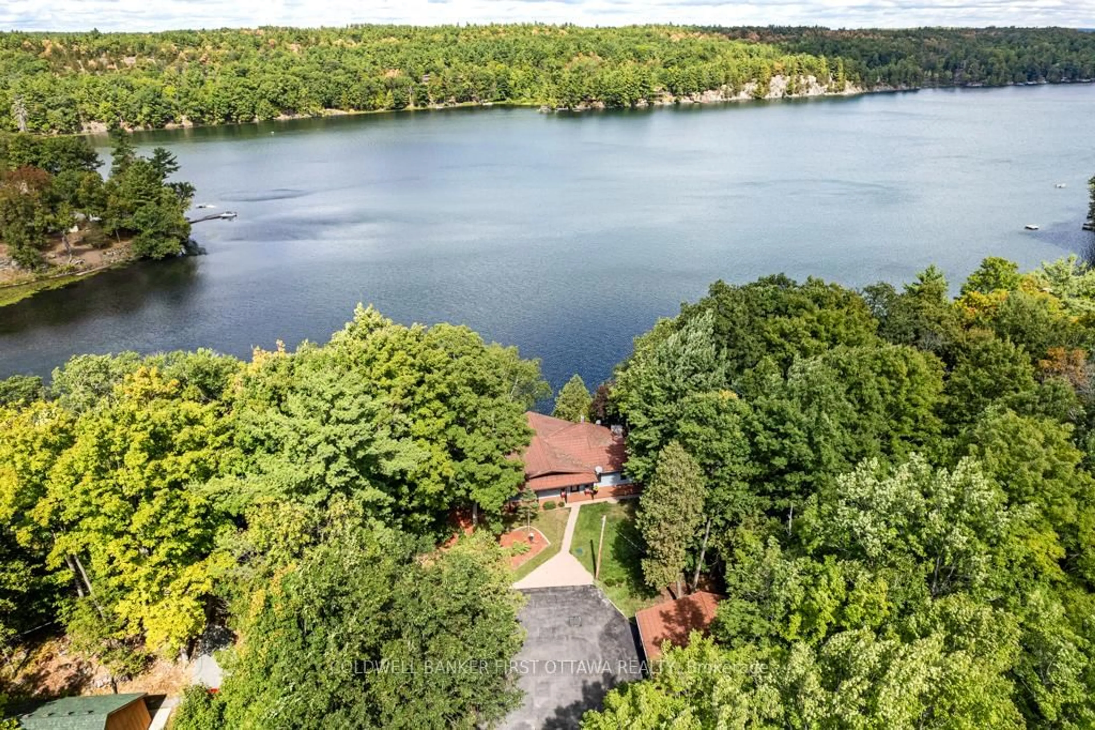 A pic from outside/outdoor area/front of a property/back of a property/a pic from drone, water/lake/river/ocean view for 1031 Shanny Bear Lane, Perth Road Ontario K0H 2L0