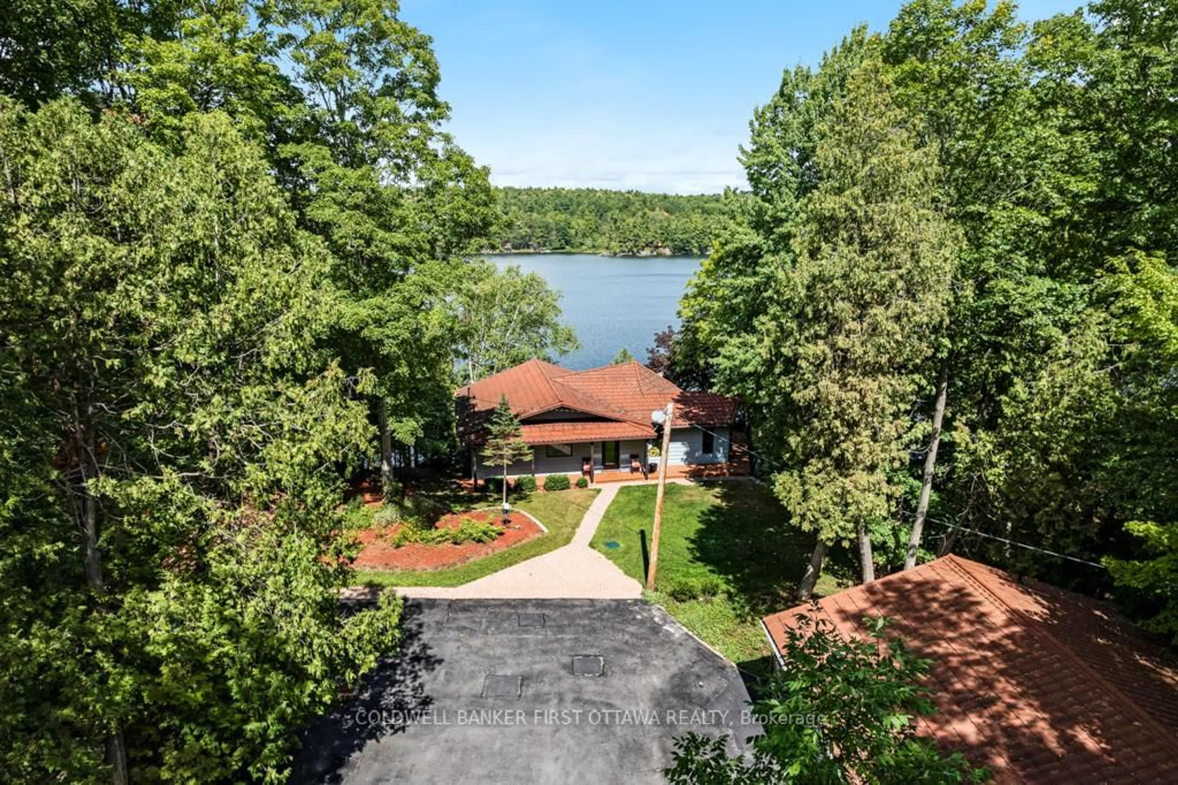 A pic from outside/outdoor area/front of a property/back of a property/a pic from drone, water/lake/river/ocean view for 1031 Shanny Bear Lane, Perth Road Ontario K0H 2L0
