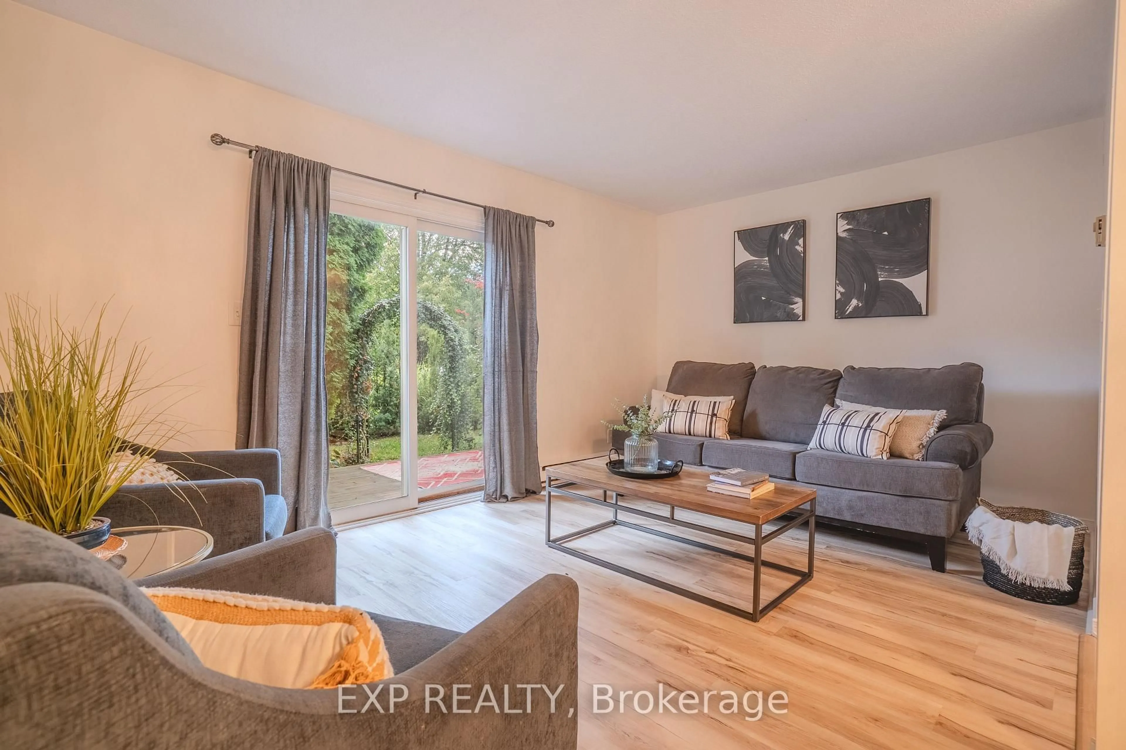 Living room with furniture, wood/laminate floor for 38 Elma St #8, St. Catharines Ontario L2N 6Z3