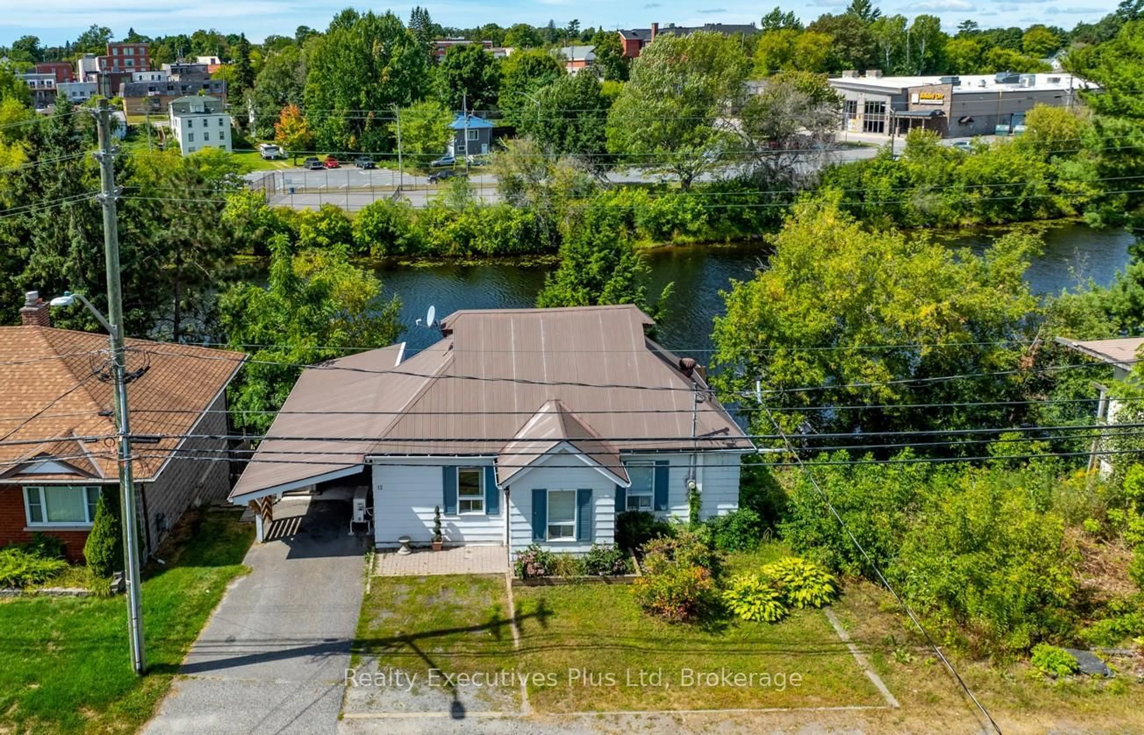 A pic from outside/outdoor area/front of a property/back of a property/a pic from drone, water/lake/river/ocean view for 12 River St, Parry Sound Ontario P2A 2T6