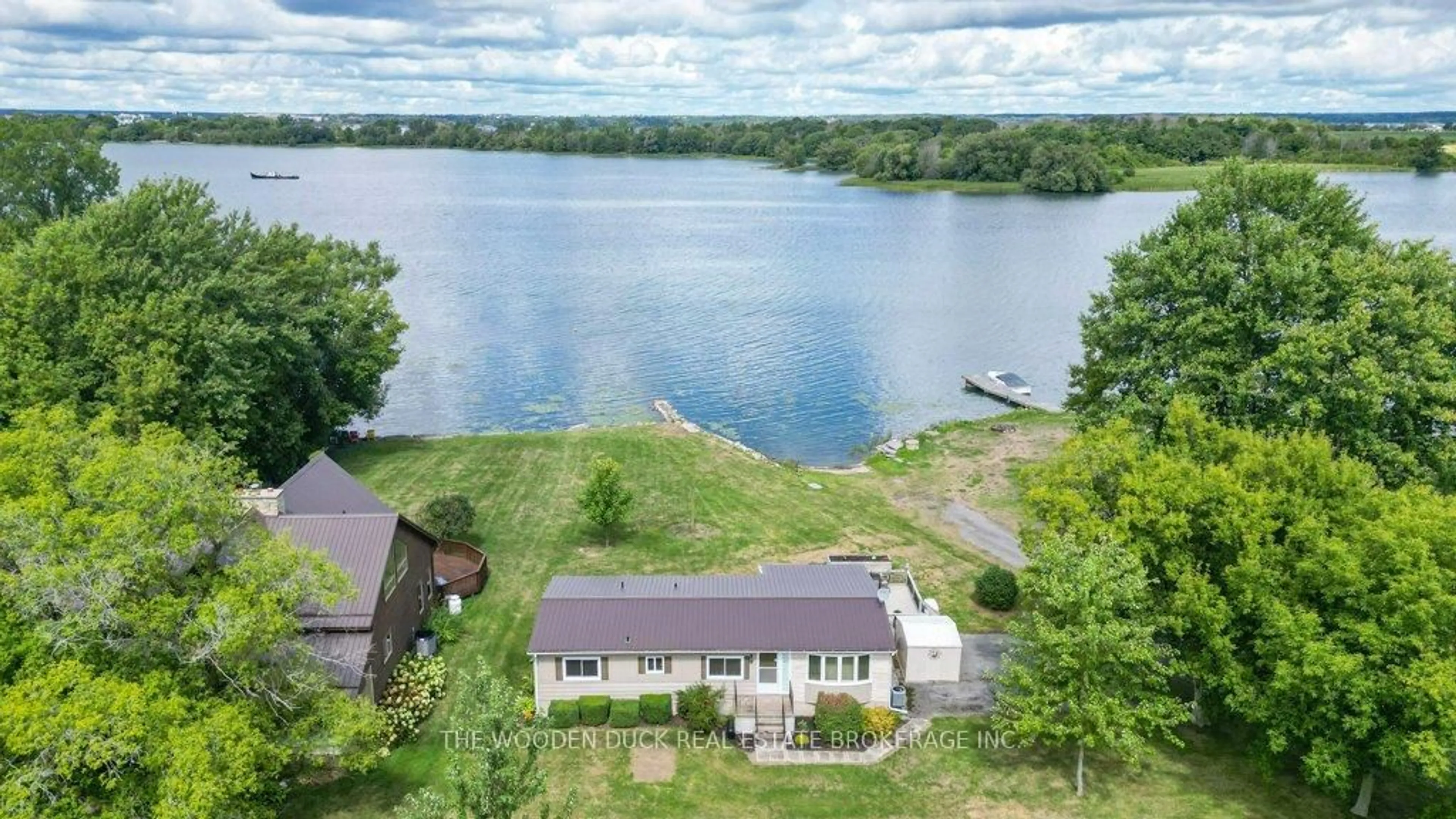A pic from outside/outdoor area/front of a property/back of a property/a pic from drone, water/lake/river/ocean view for 1314 96 Highway, Wolfe Island Ontario K0H 2Y0