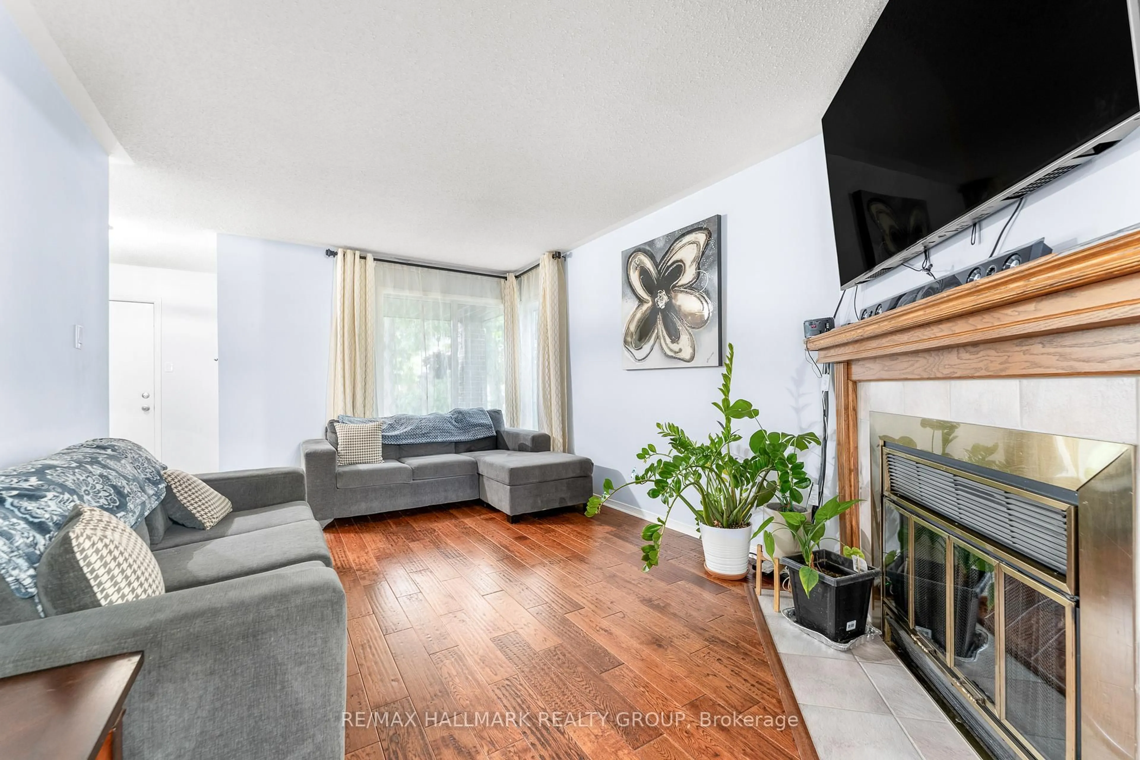 Living room with furniture, wood/laminate floor for 59 Shearer Cres, Kanata Ontario K2L 3N3