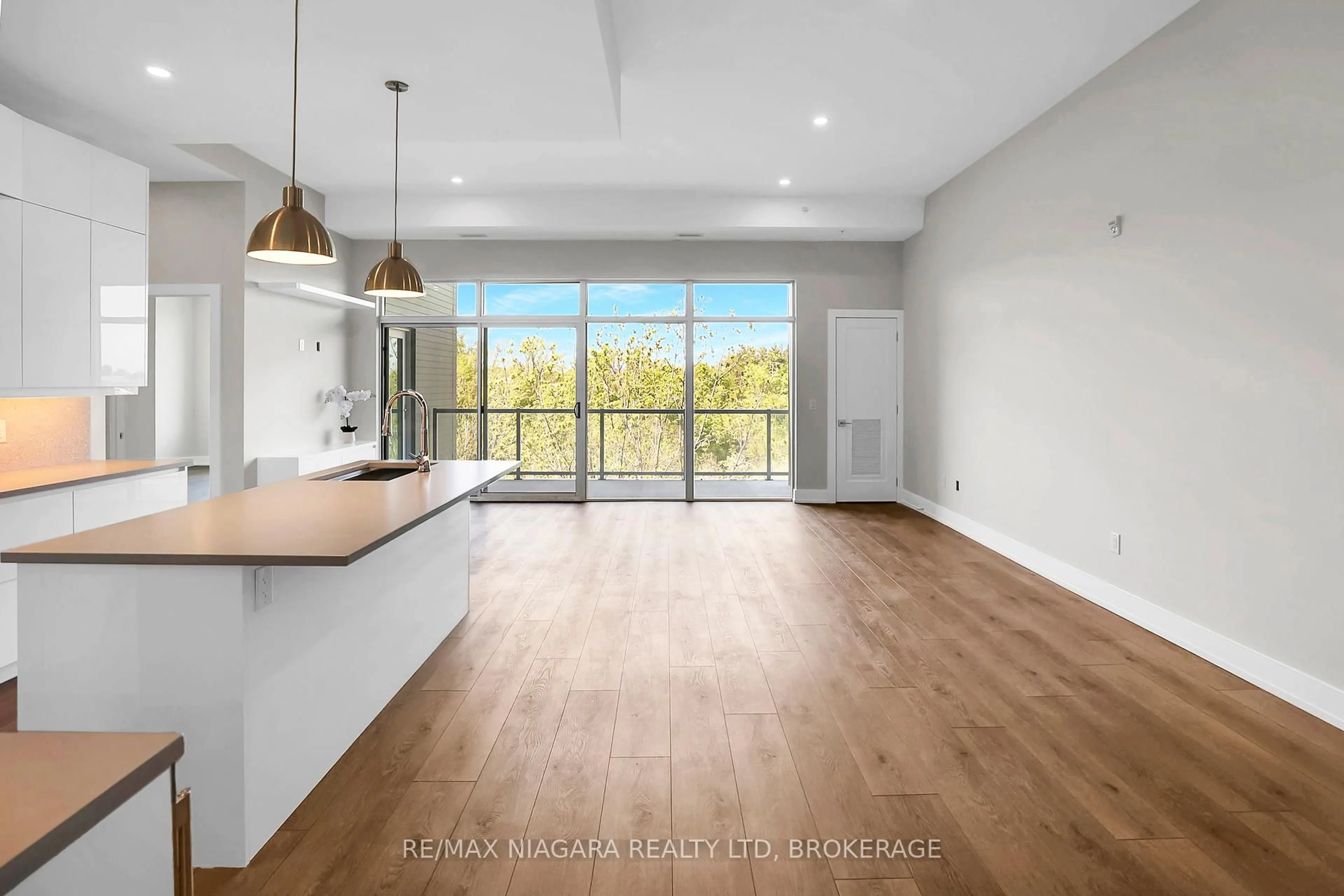Open concept kitchen, wood/laminate floor for 77 Yates St #505, St. Catharines Ontario L2R 5R7
