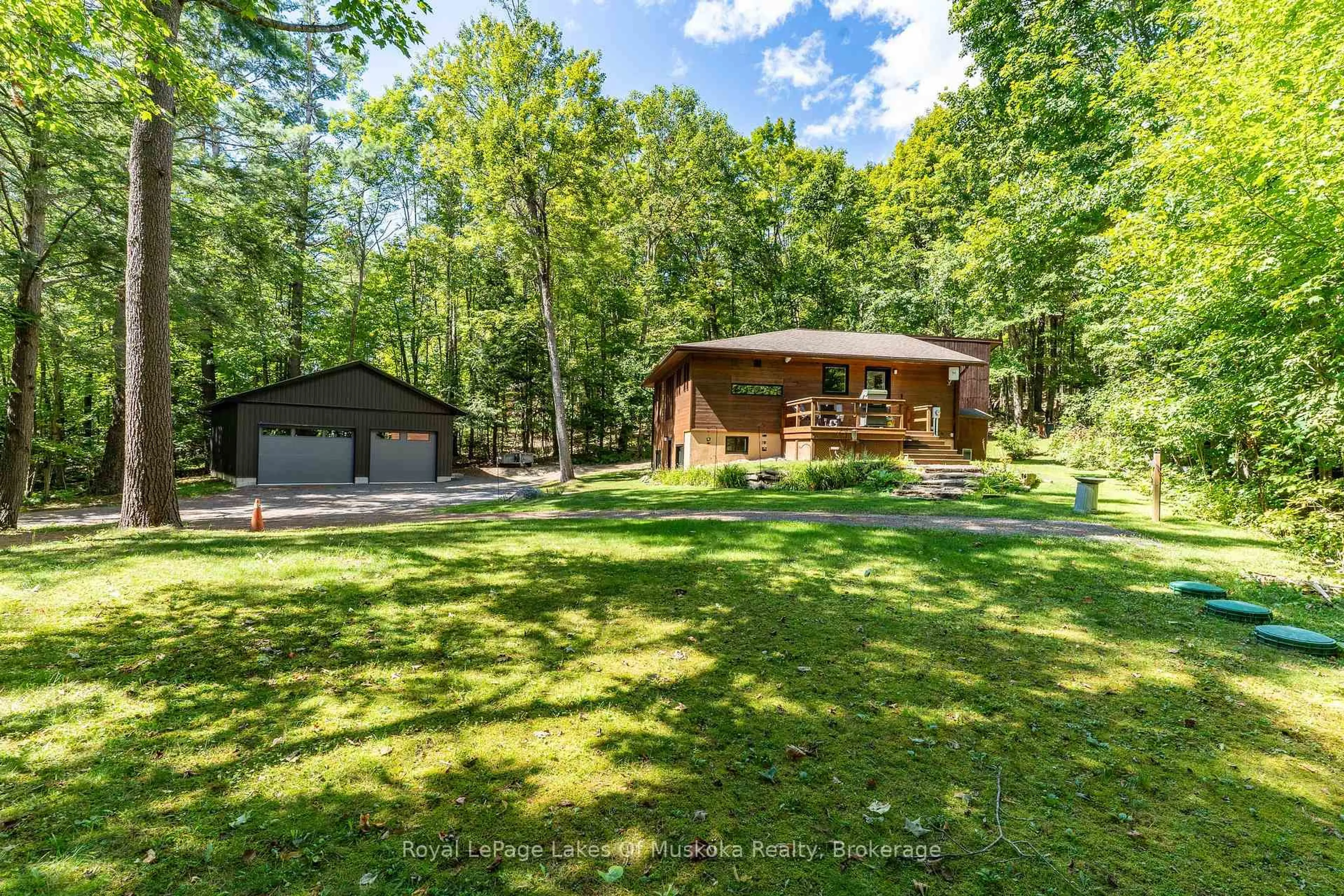A pic from outside/outdoor area/front of a property/back of a property/a pic from drone, forest/trees view for 1056 Golden Beach Rd, Bracebridge Ontario P1L 1W8