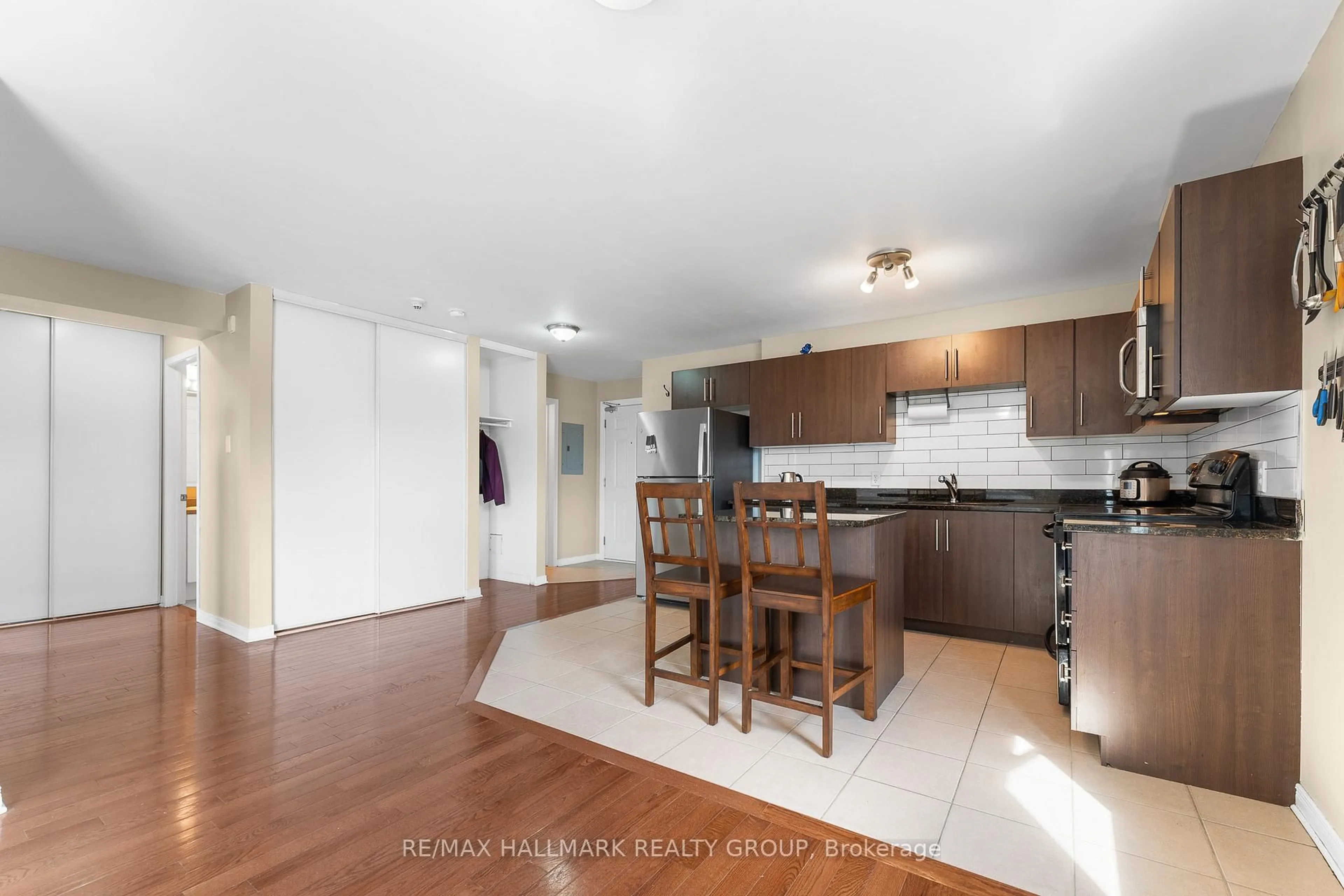 Open concept kitchen, wood/laminate floor for 646 Cummings Ave #401, Ottawa Ontario K1K 2K6