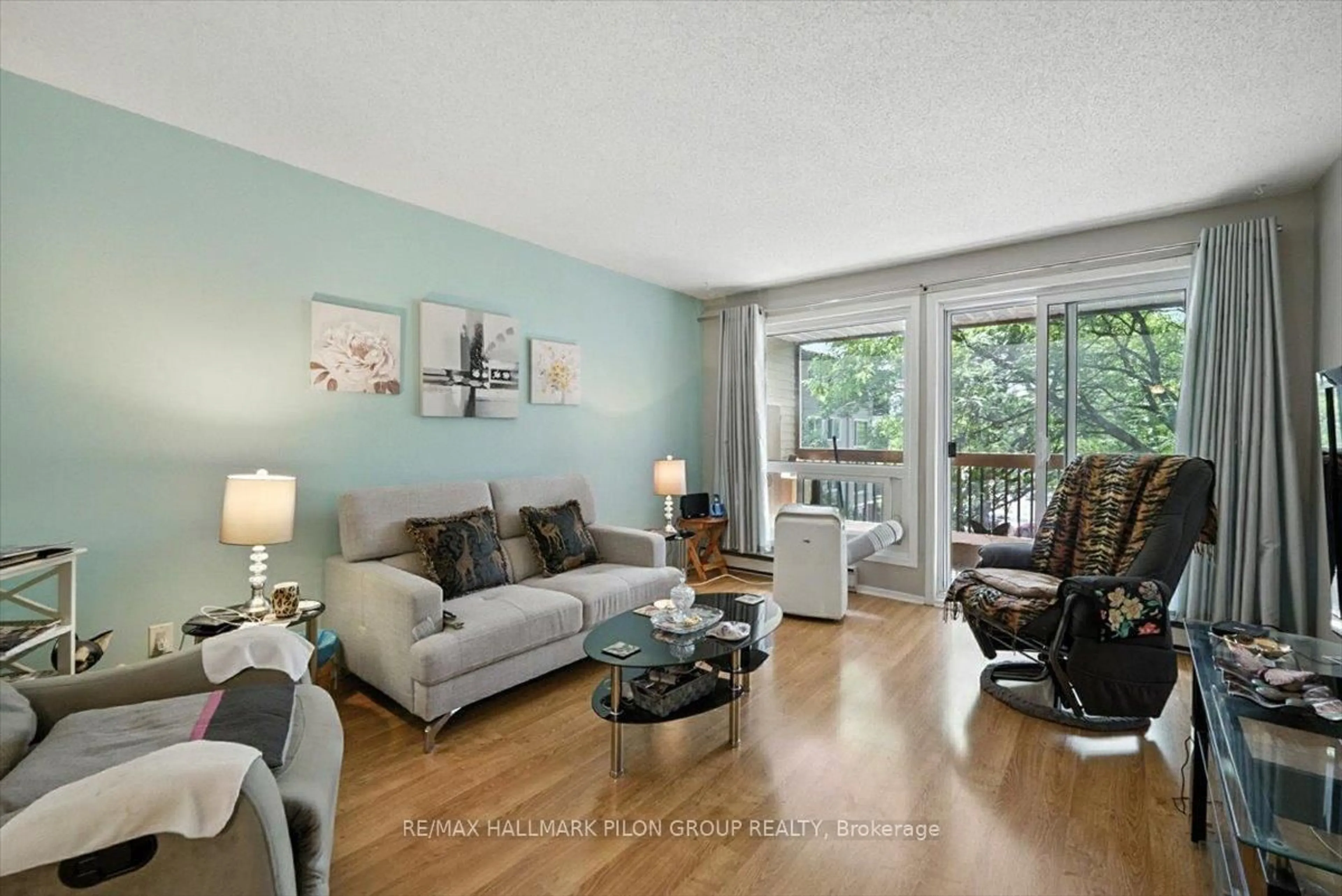 Living room with furniture, wood/laminate floor for 6434 Bilberry Dr #315, Ottawa Ontario K1C 4P5