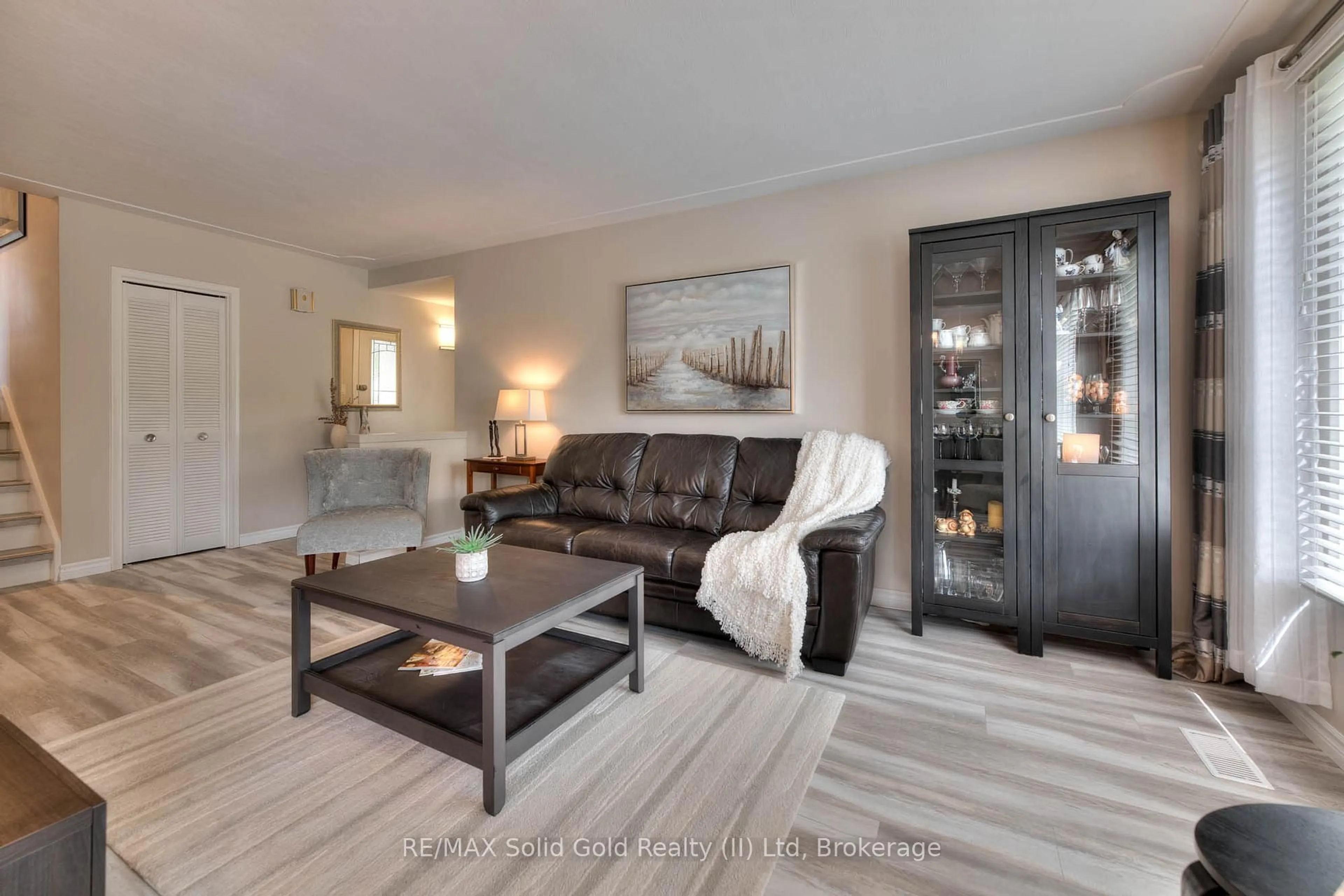 Living room with furniture, wood/laminate floor for 232 Kenneth Ave, Kitchener Ontario N2A 1W4