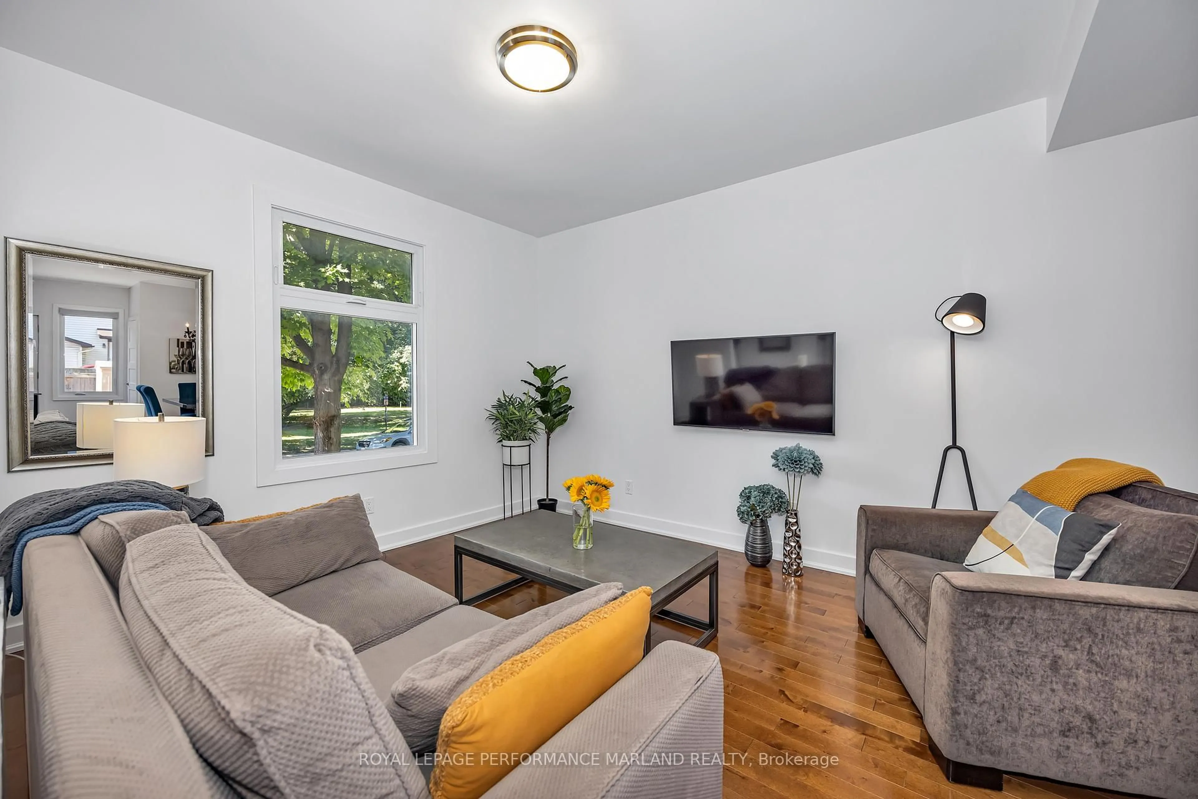 Living room with furniture, wood/laminate floor for 174 Hawthorne Ave, Ottawa Ontario K1S 0B5