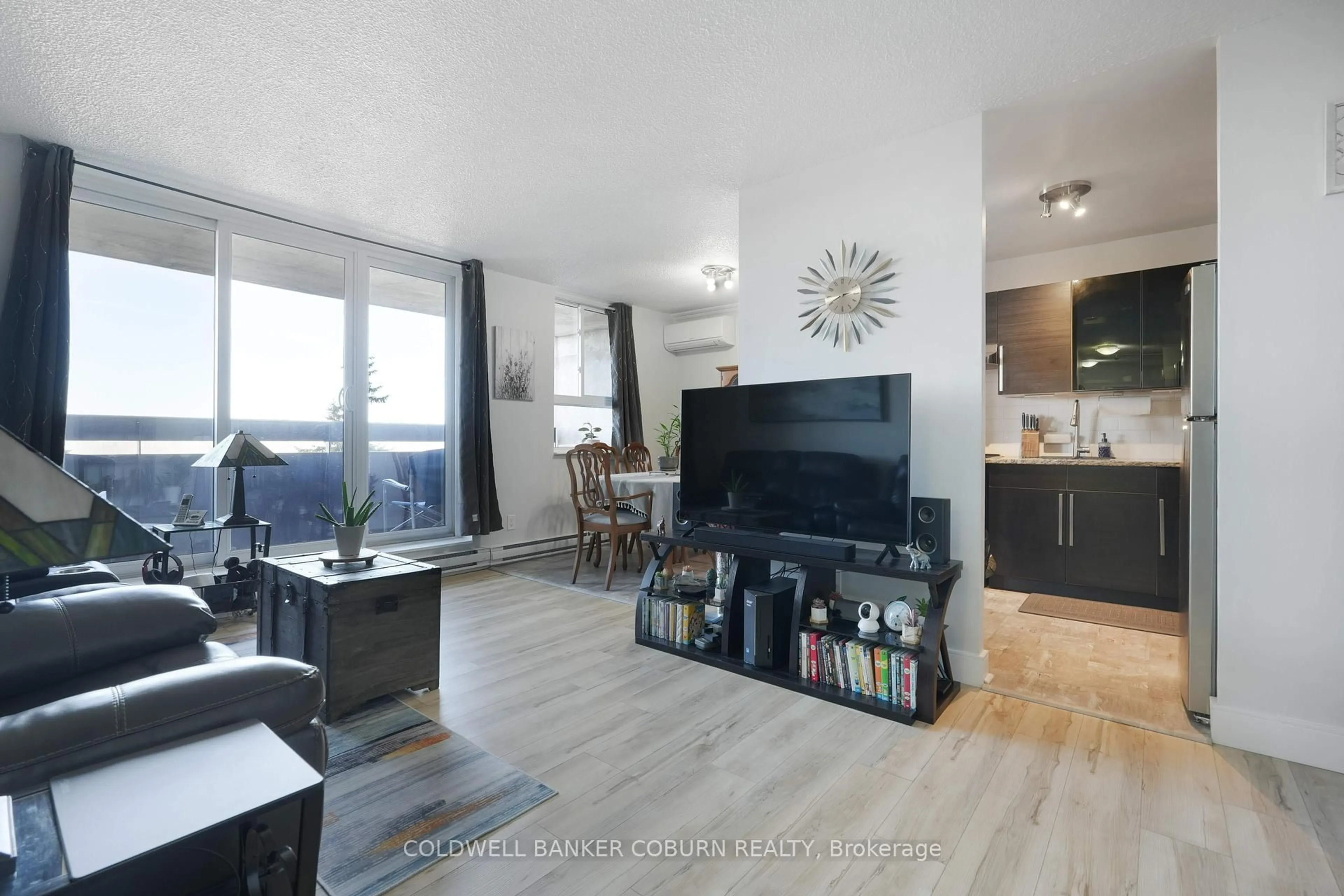 Living room with furniture, wood/laminate floor for 2020 Jasmine Cres #614, Ottawa Ontario K1J 8K5