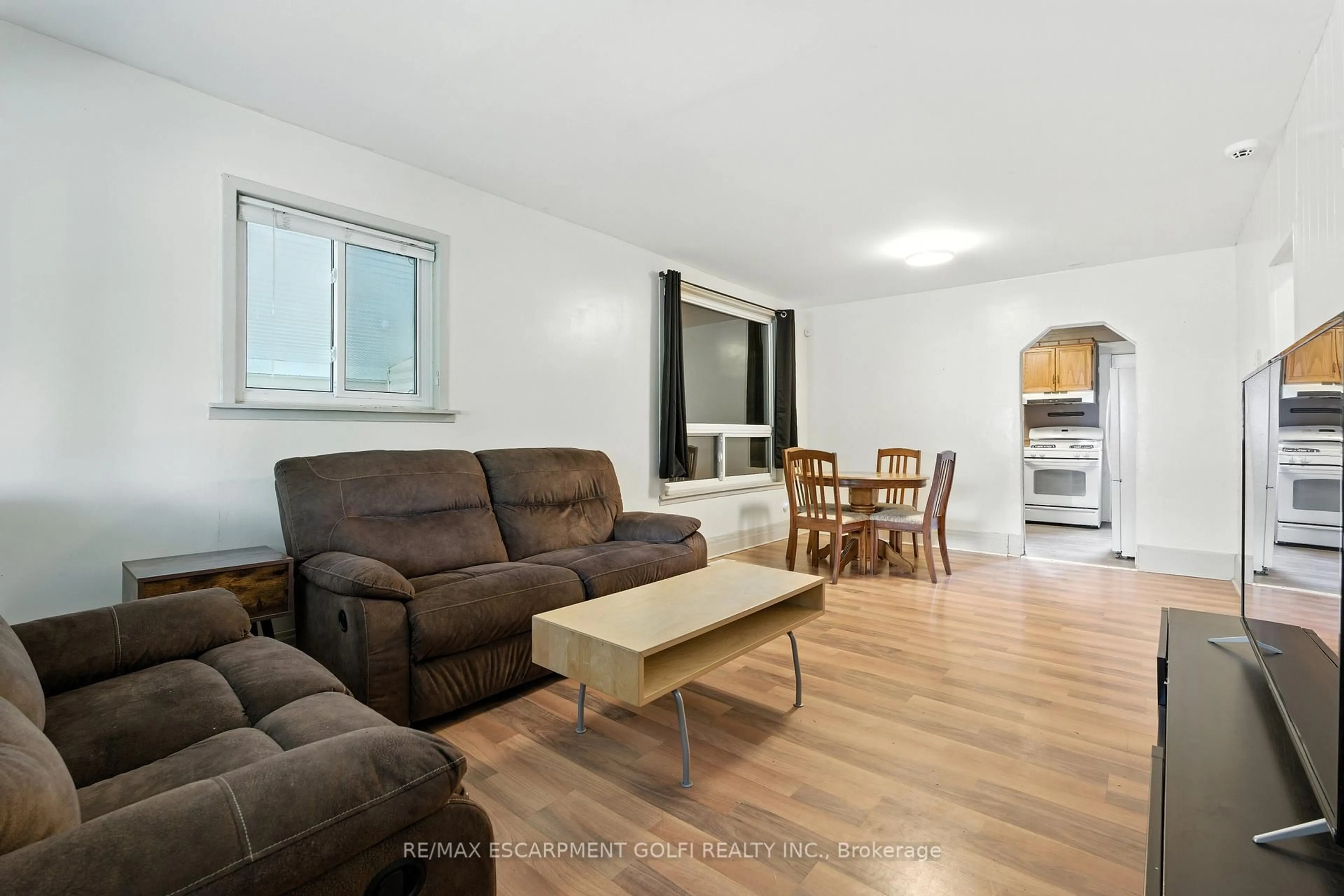 Living room with furniture, wood/laminate floor for 1 Berryman Ave, St. Catharines Ontario L2R 3W8