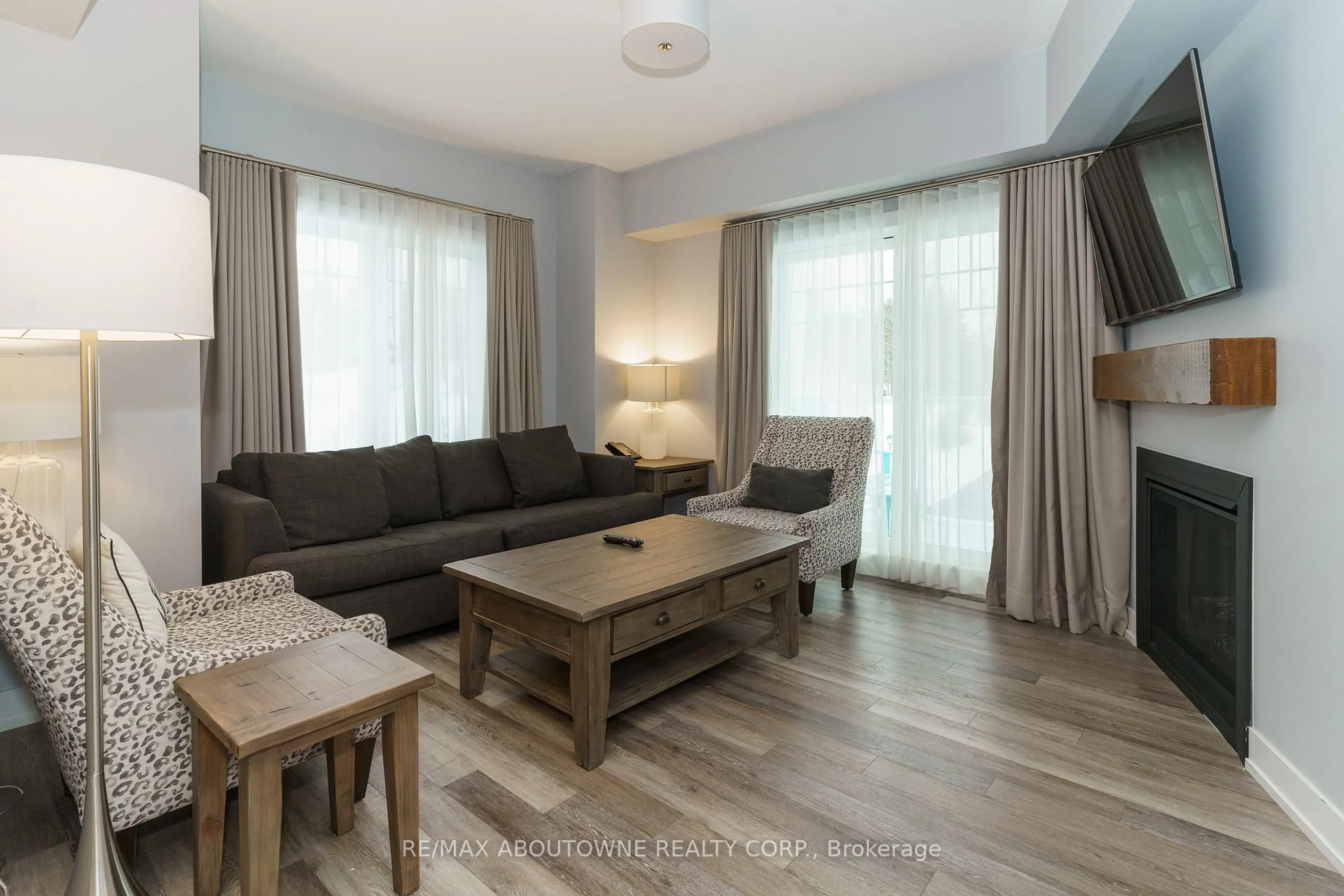 Living room with furniture, wood/laminate floor for 25 PEN LAKE POINT Rd #332, Huntsville Ontario P1H 1A9