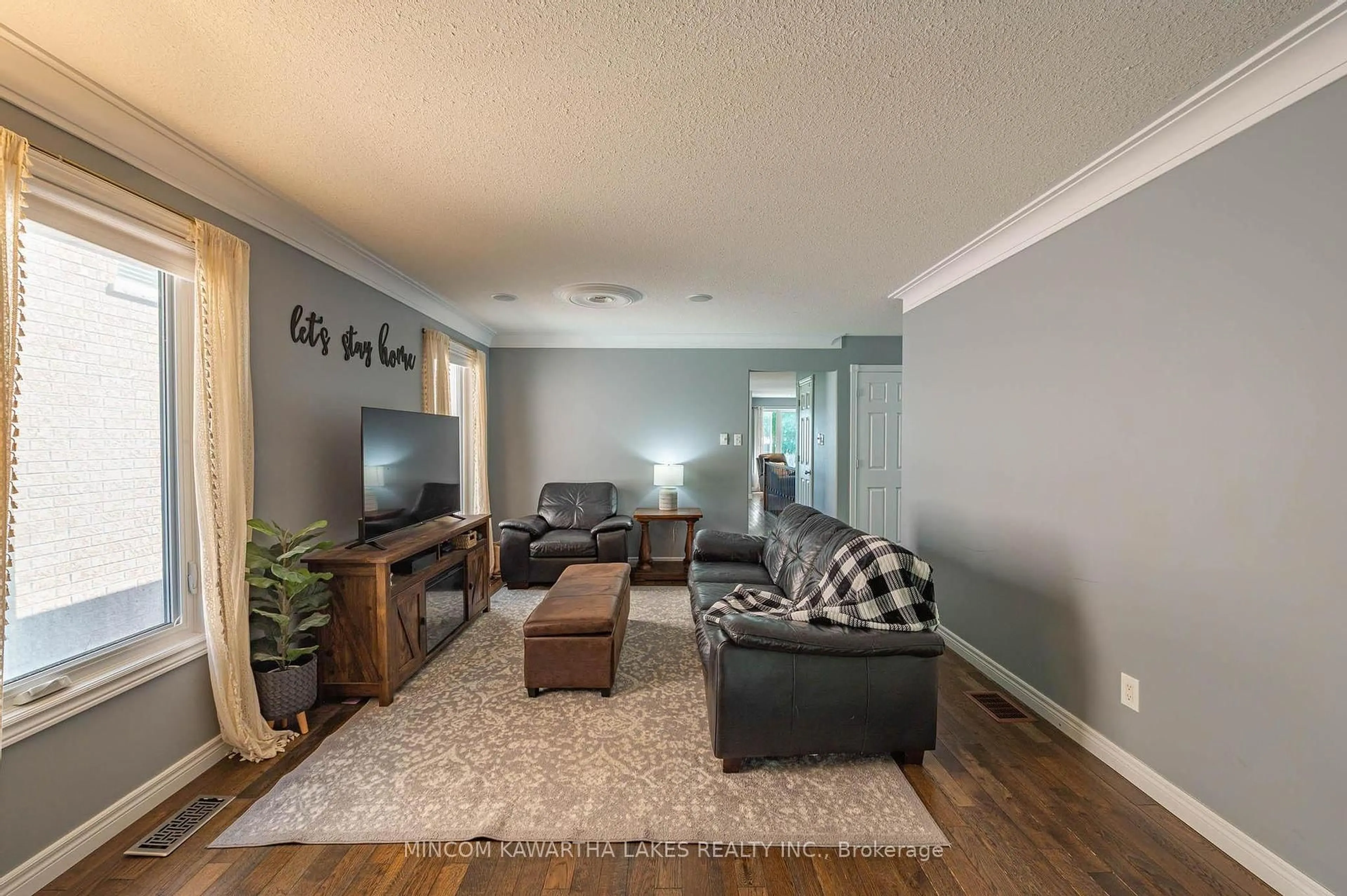 Living room with furniture, wood/laminate floor for 1247 Haggis Dr, Peterborough Ontario K9K 2S9