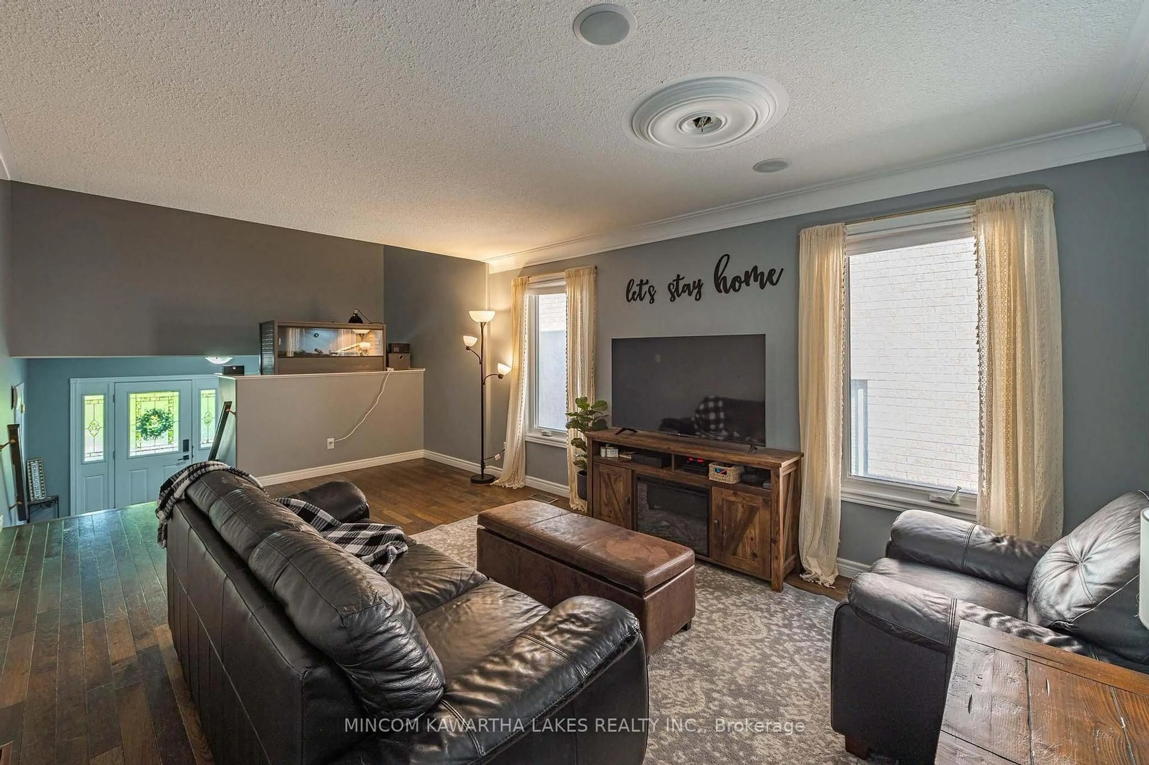 Living room with furniture, wood/laminate floor for 1247 Haggis Dr, Peterborough Ontario K9K 2S9
