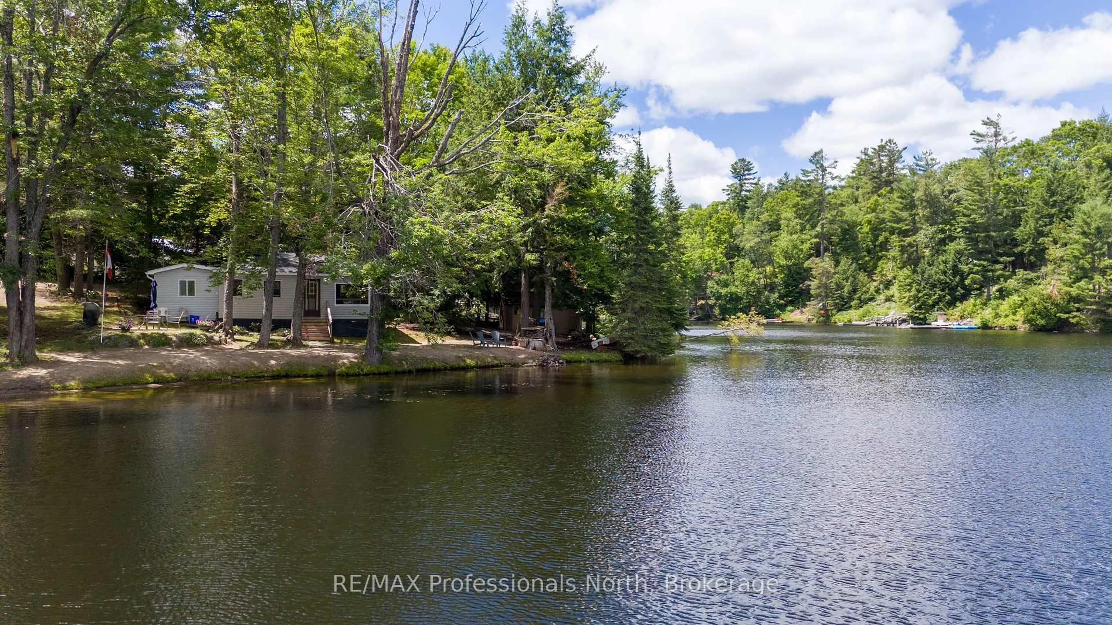 A pic from outside/outdoor area/front of a property/back of a property/a pic from drone, water/lake/river/ocean view for 1073 Ward Lane, Bracebridge Ontario P1L 1X1