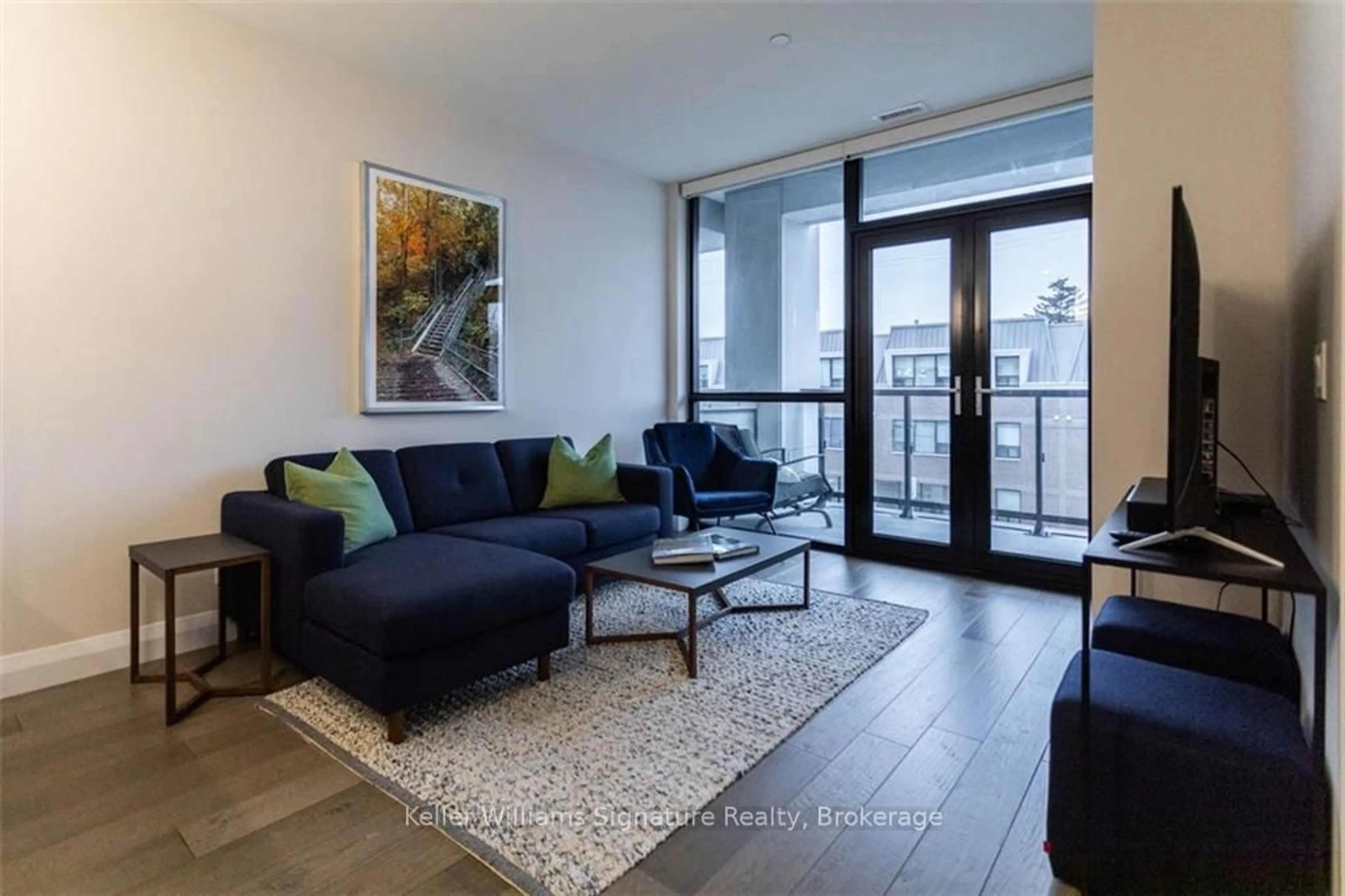 Living room with furniture, wood/laminate floor for 101 Locke St #207, Hamilton Ontario L8P 4A6
