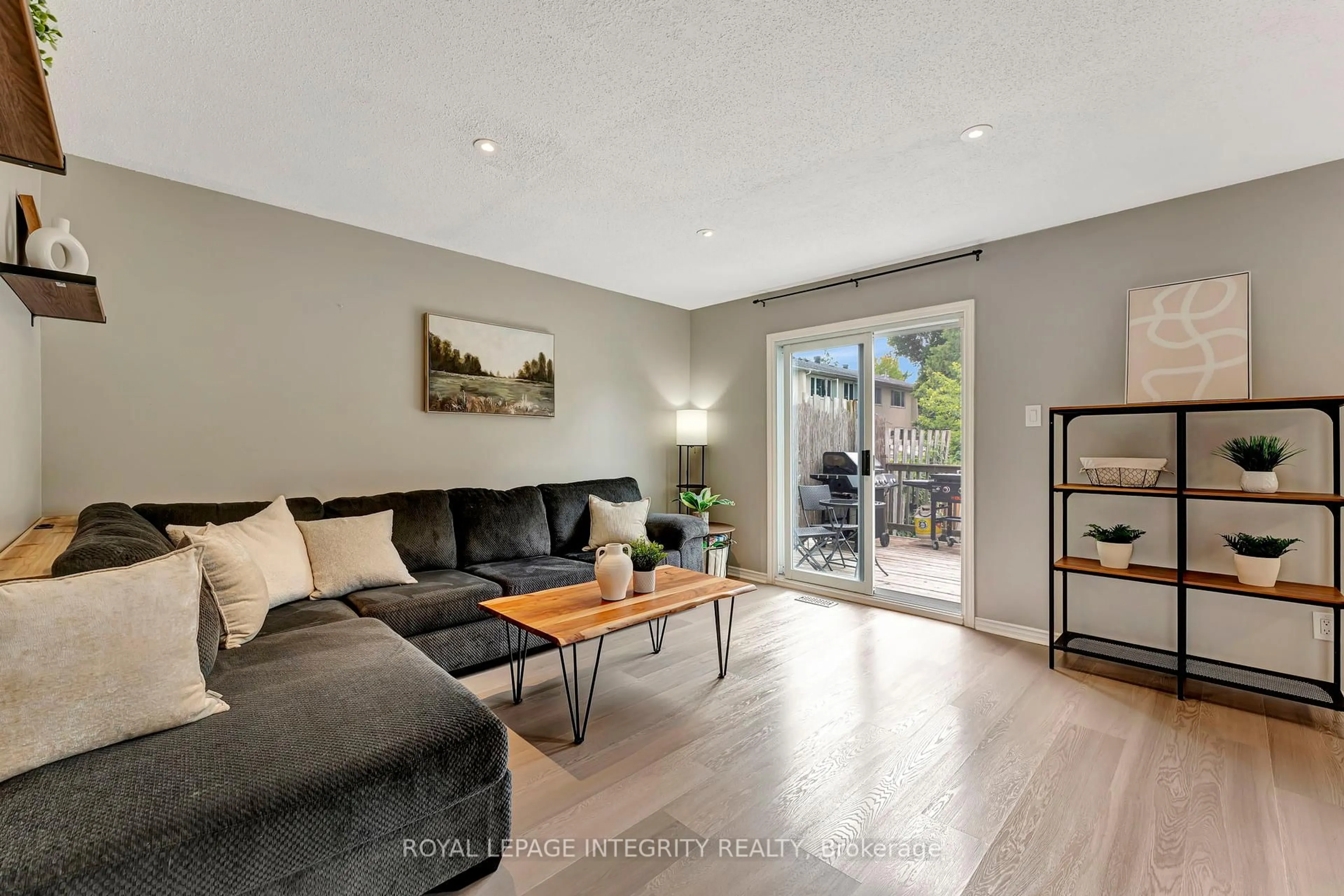 Living room with furniture, wood/laminate floor for 66 Tarquin Cres, Ottawa Ontario K2H 8J9