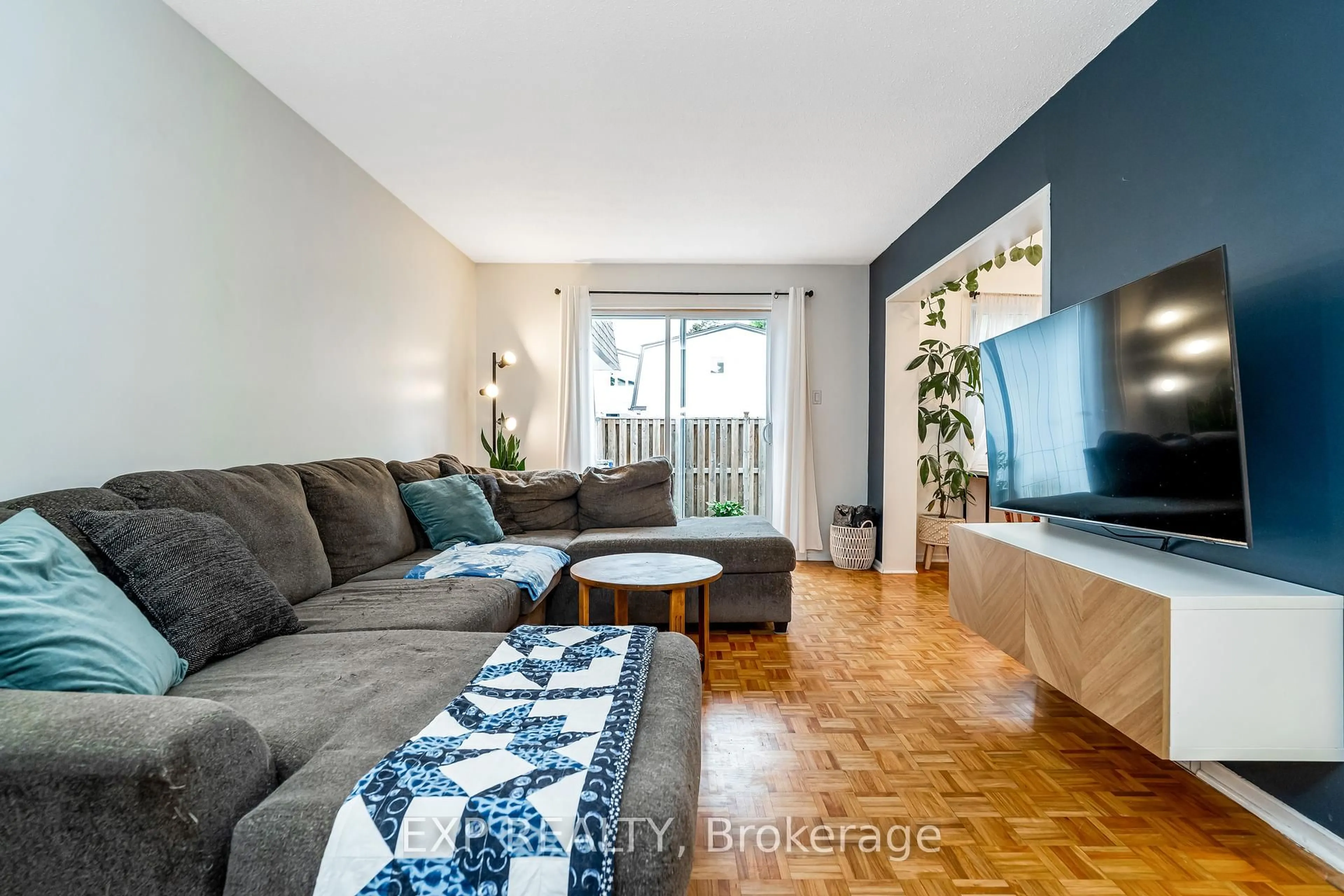 Living room with furniture, wood/laminate floor for 837 Eastvale Dr #78, Ottawa Ontario K1J 7T5