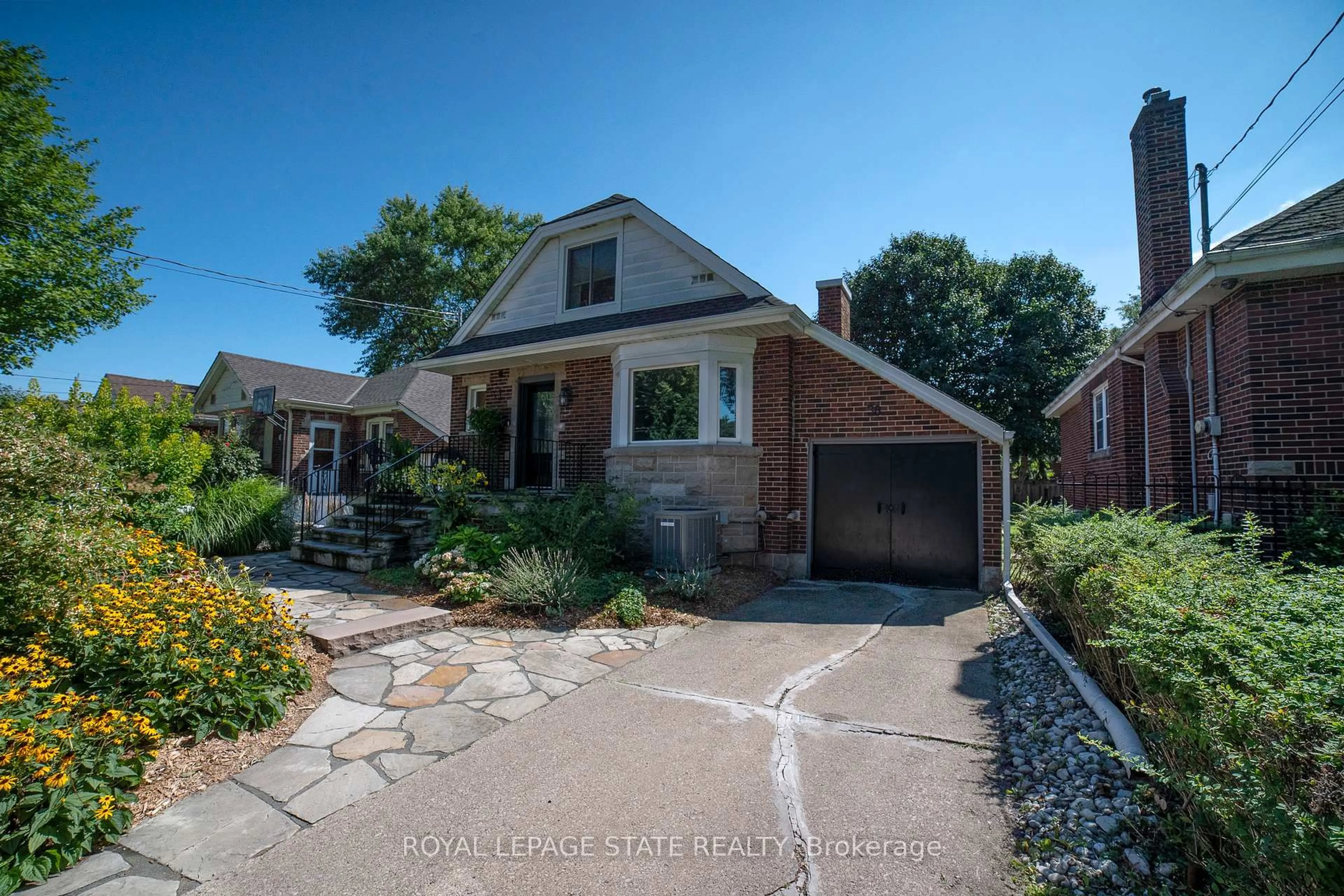 Home with brick exterior material, street for 38 Kenmore Rd, Hamilton Ontario L8S 3T7