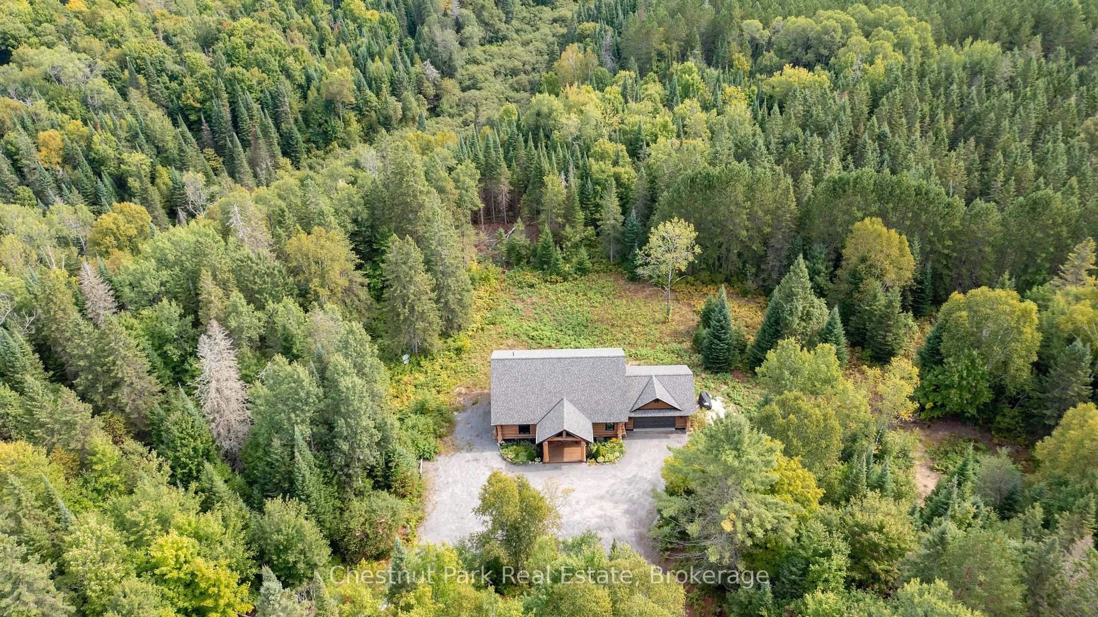 A pic from outside/outdoor area/front of a property/back of a property/a pic from drone, forest/trees view for 1363 Williamsport Rd, Huntsville Ontario P1H 2J4