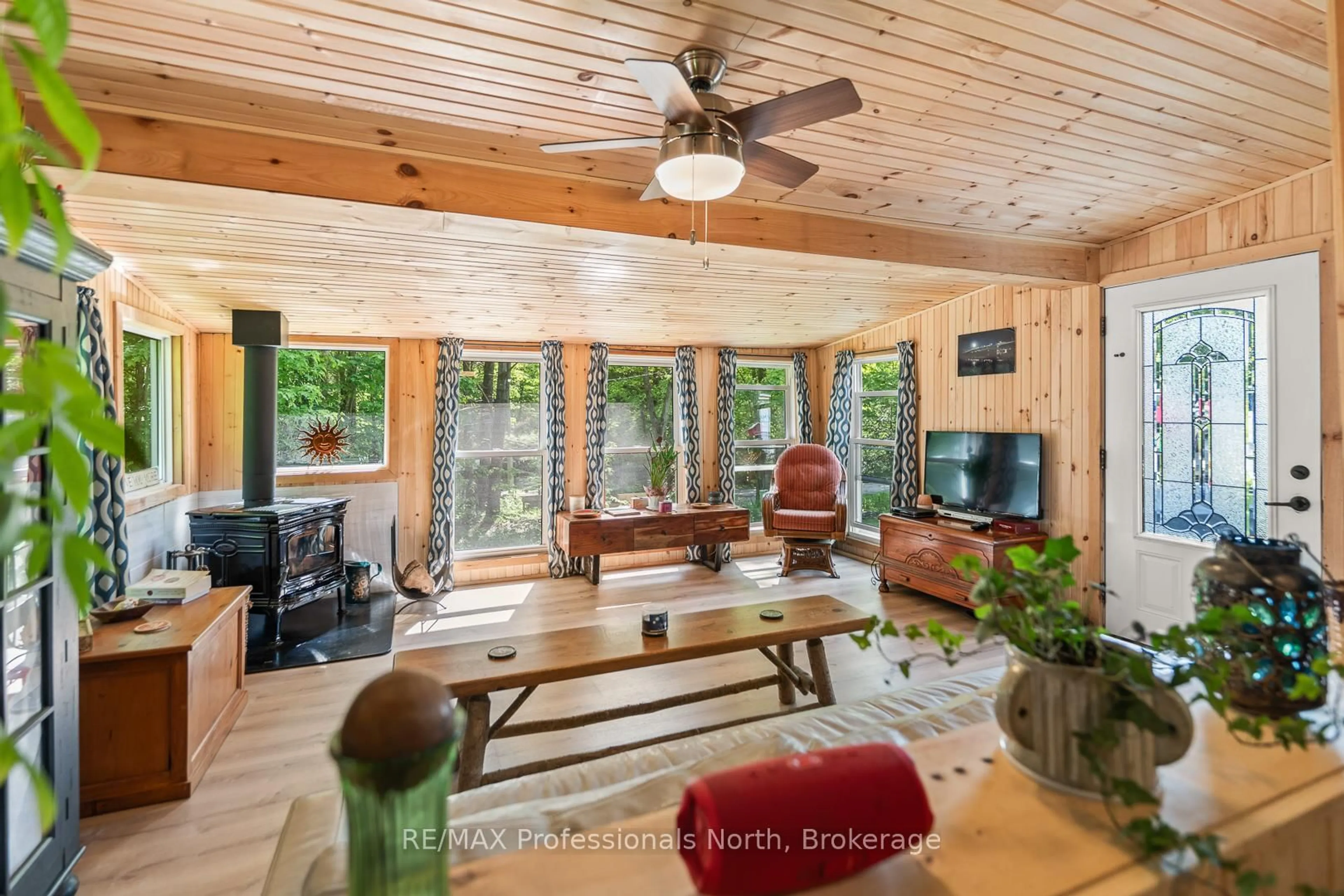 Living room with furniture, wood/laminate floor for 1053 Cutler Rd, Muskoka Lakes Ontario P0B 1M0