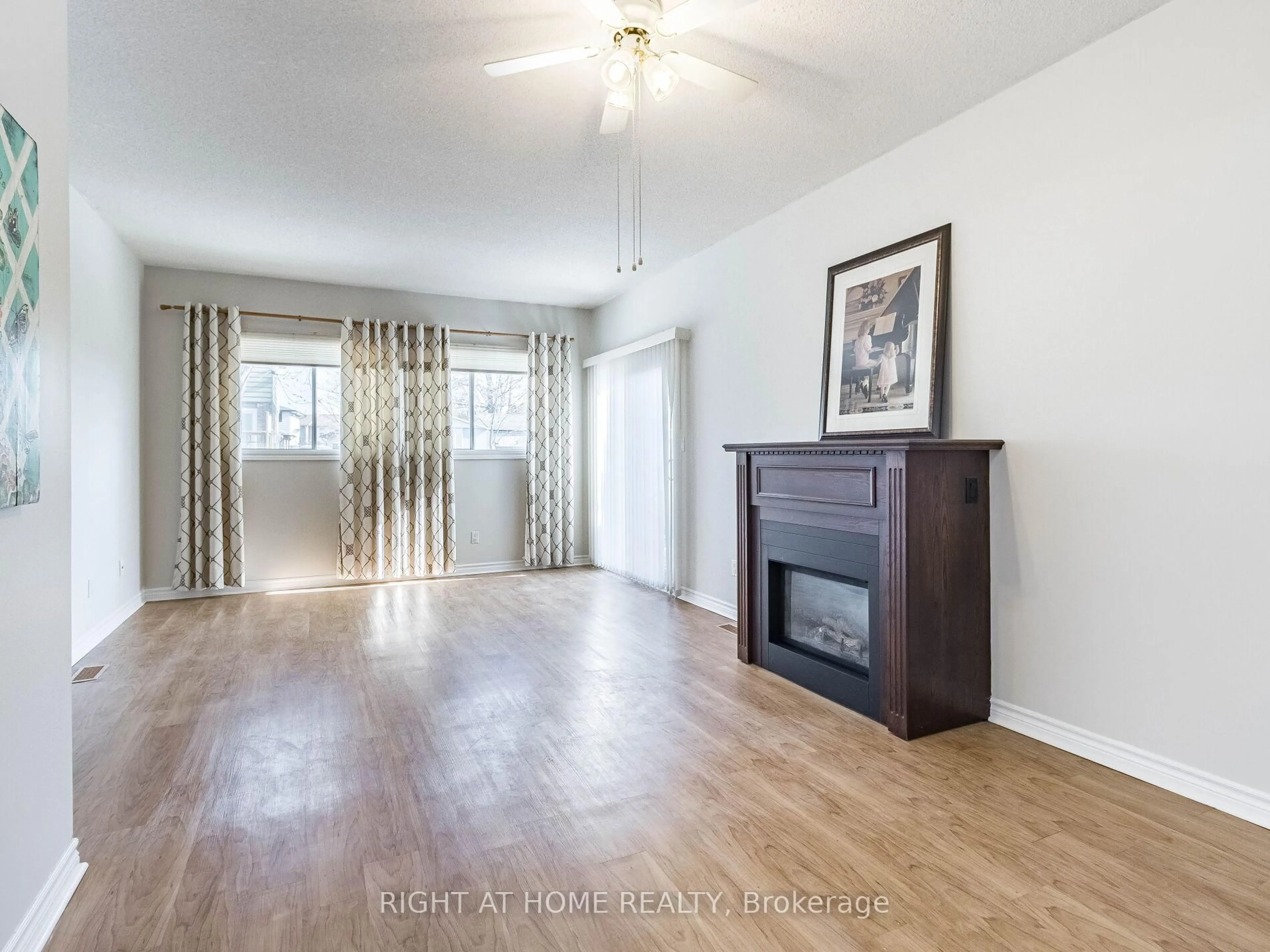 Living room with furniture, wood/laminate floor for 24 The Meadows St, St. Catharines Ontario L2N 7L1