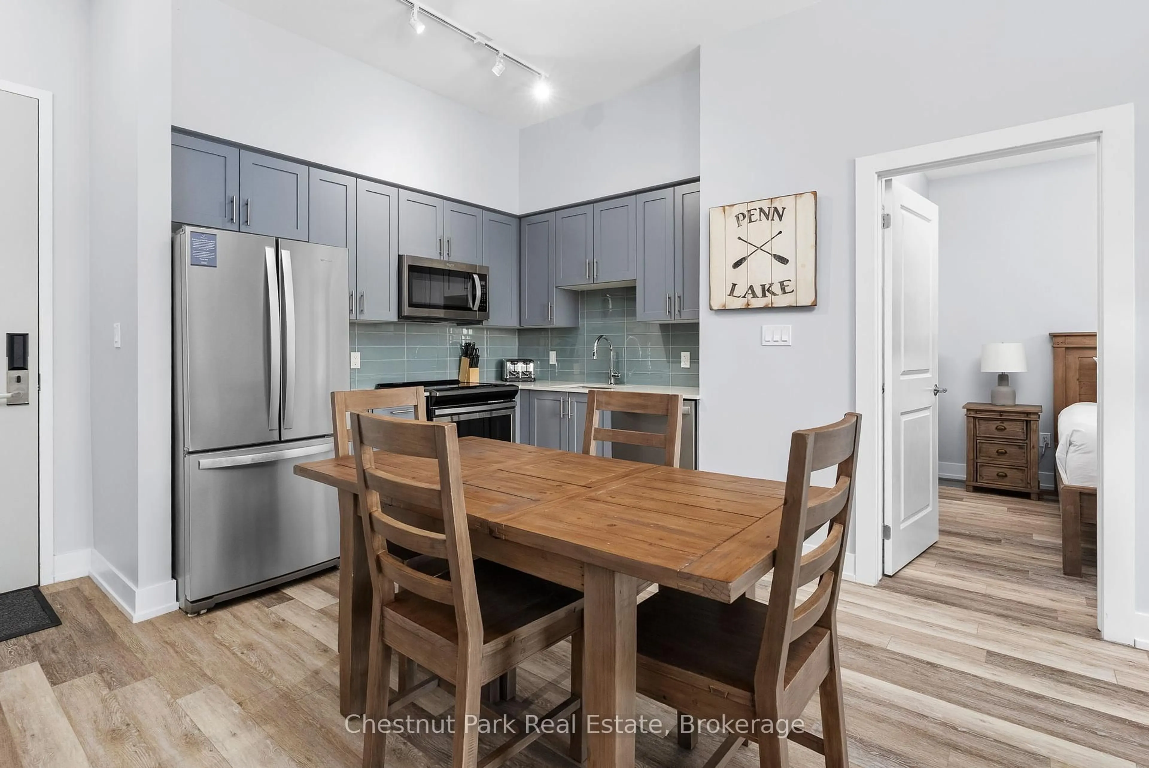 Open concept kitchen, wood/laminate floor for 25 Pen Lake Point Rd #117, Huntsville Ontario P1H 1A9