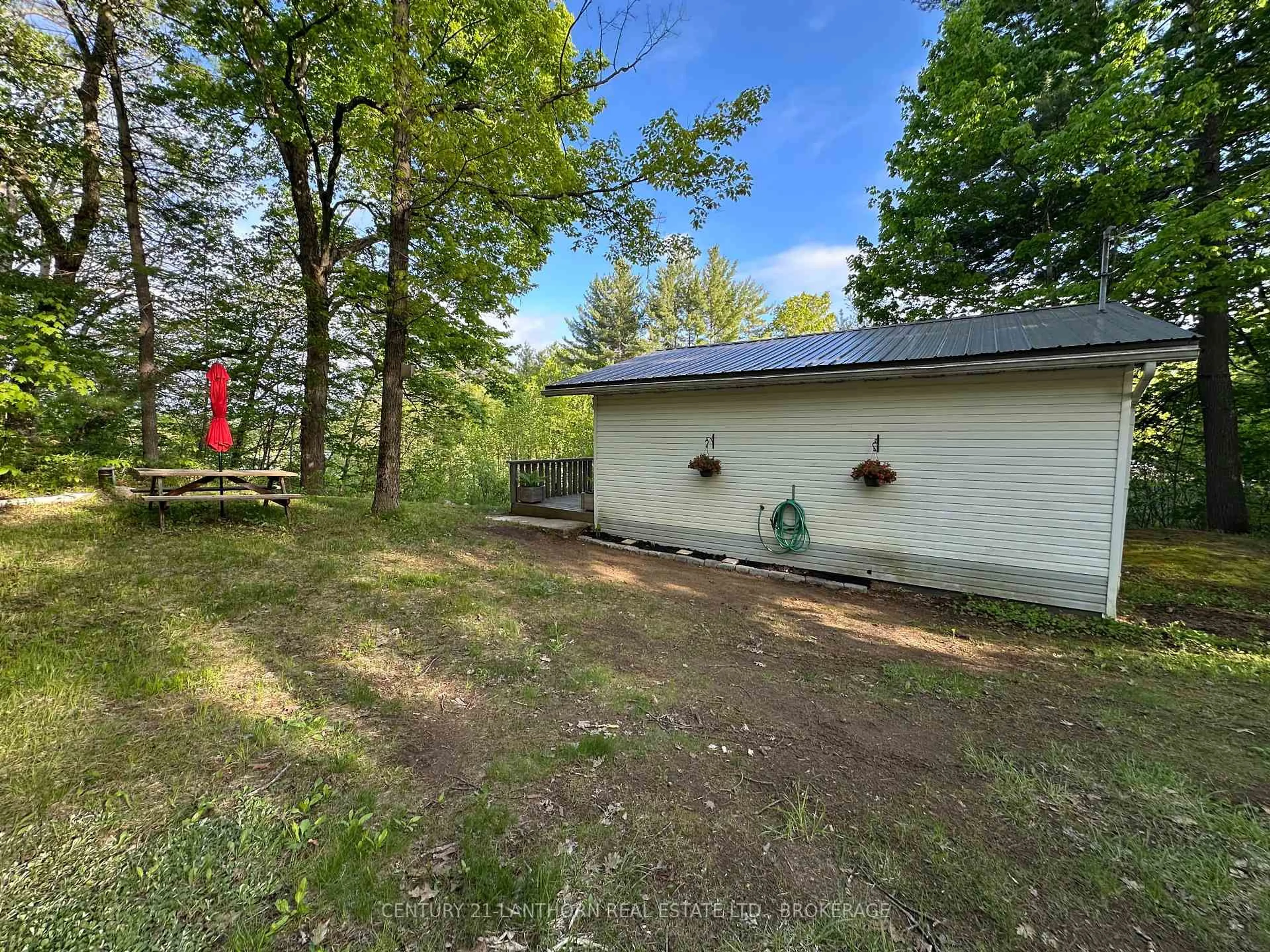 A pic from outside/outdoor area/front of a property/back of a property/a pic from drone, forest/trees view for 1024 Harrington Lane, Arden Ontario K0H 1B0