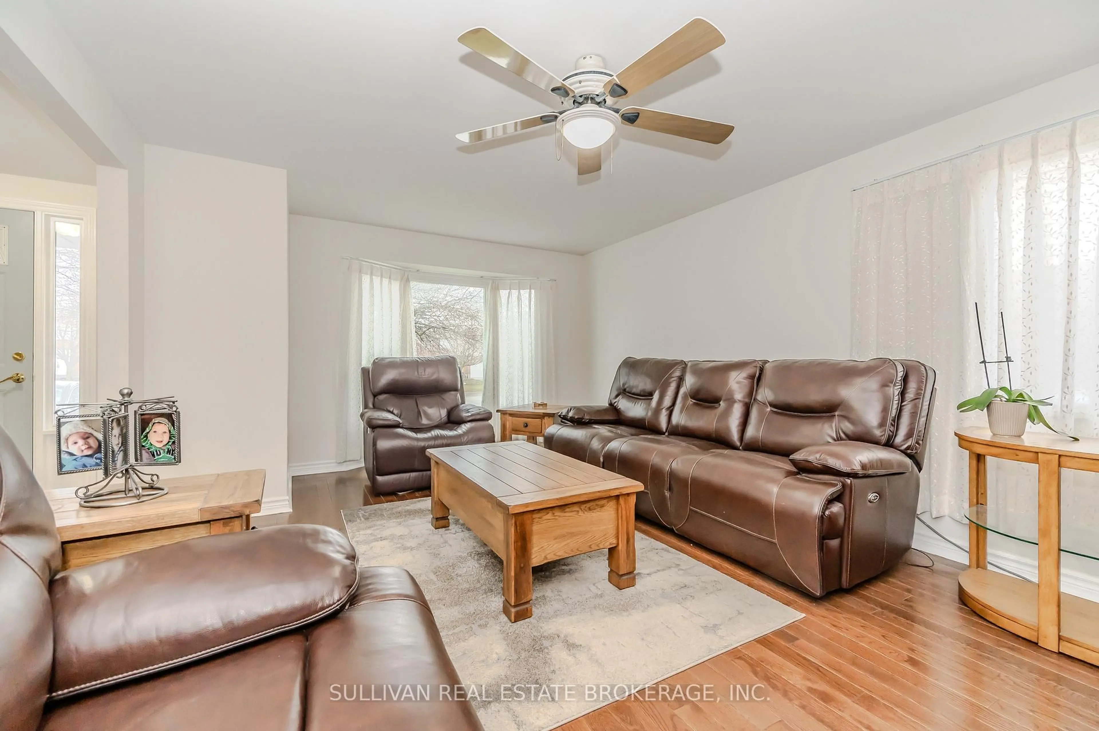 Living room with furniture, wood/laminate floor for 241 Elmira Rd, Guelph Ontario N1K 1R1