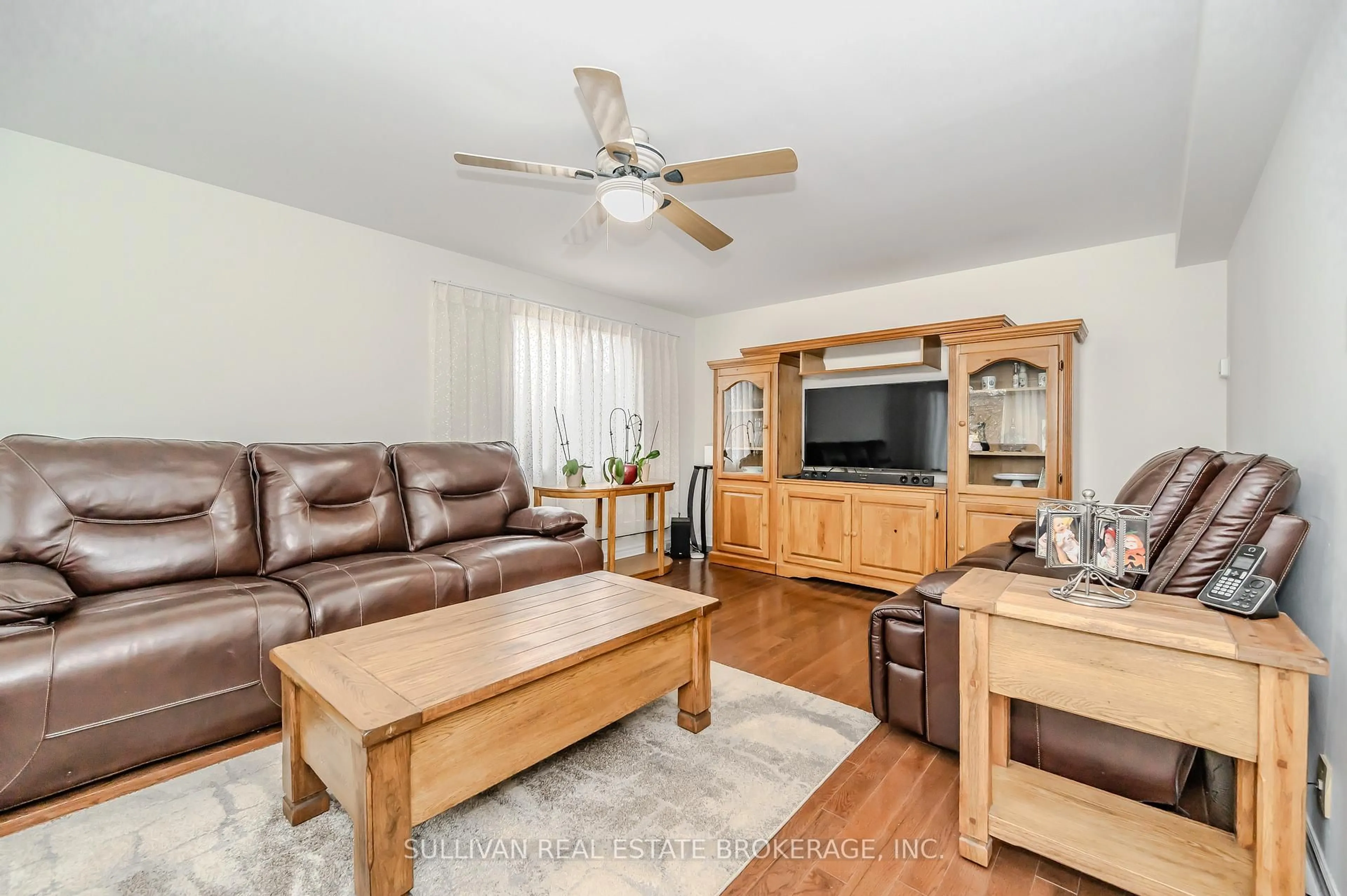 Living room with furniture, wood/laminate floor for 241 Elmira Rd, Guelph Ontario N1K 1R1