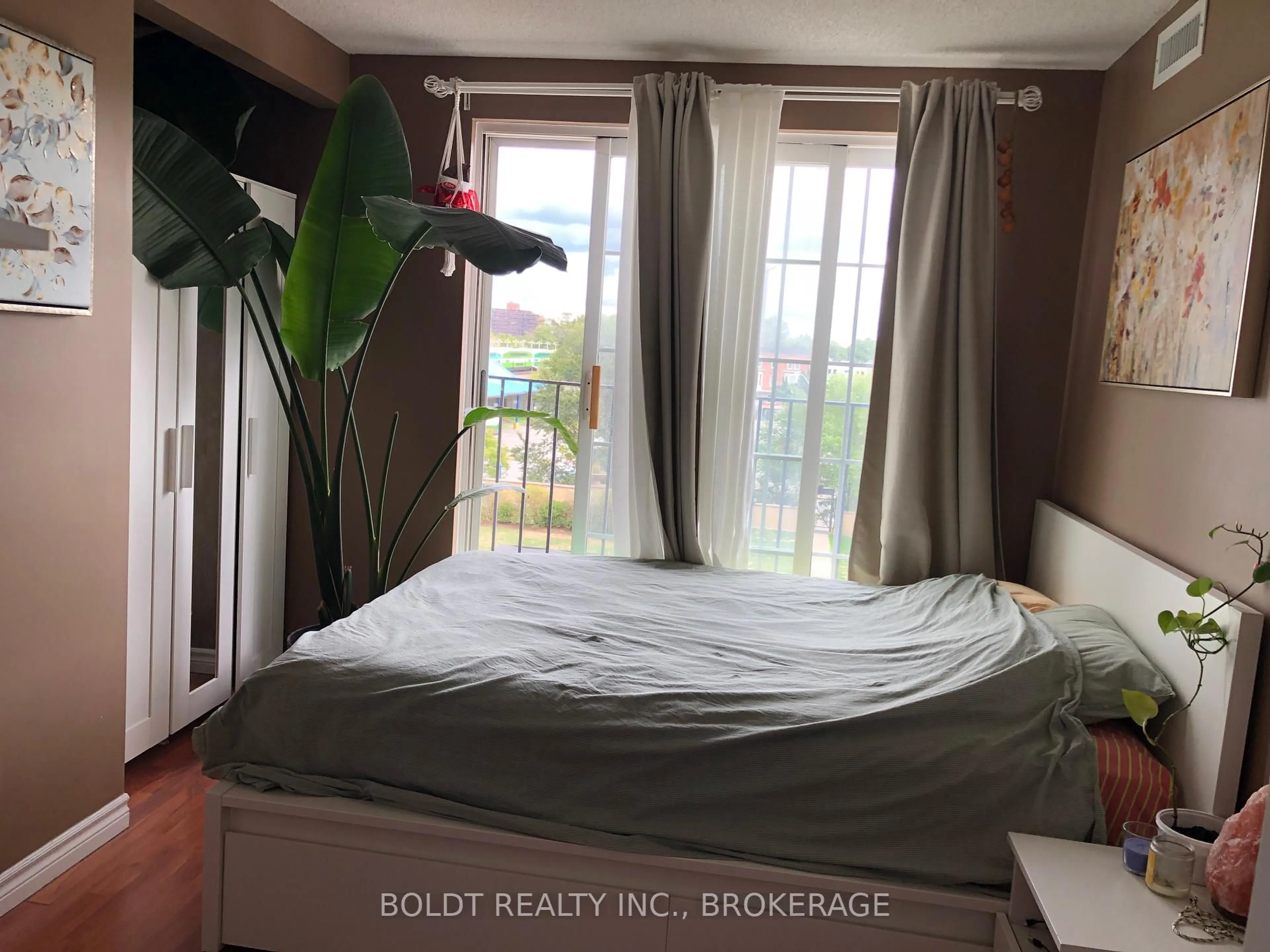 Bedroom with bed, wood/laminate floor for 135 James St S 304 St, Hamilton Ontario L8P 2Z6